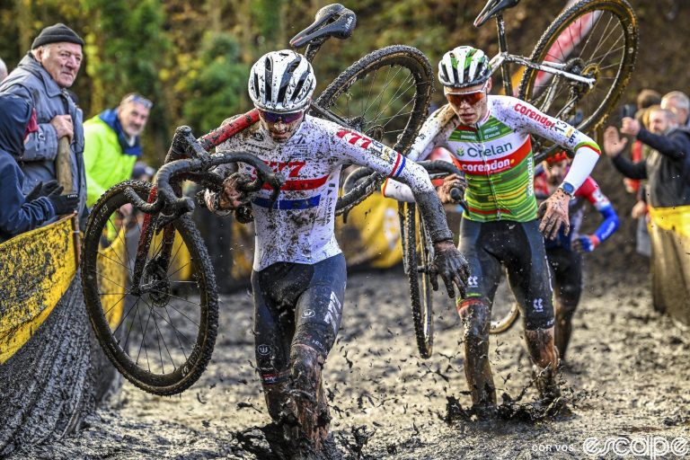 Cameron Mason leads Witse Meussen through the muck at the Superprestige Niel cyclocross race. both are ankle-deep in mud running with their bikes.
