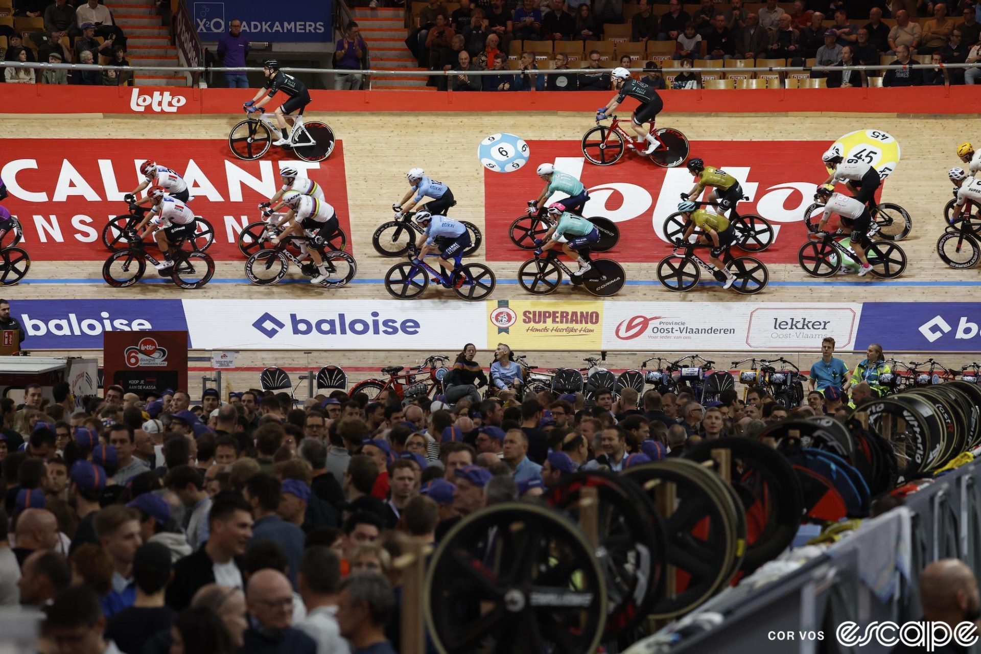 Track cyclists warm up in pairs before the start of a Madison round at the Gent Six Day.
