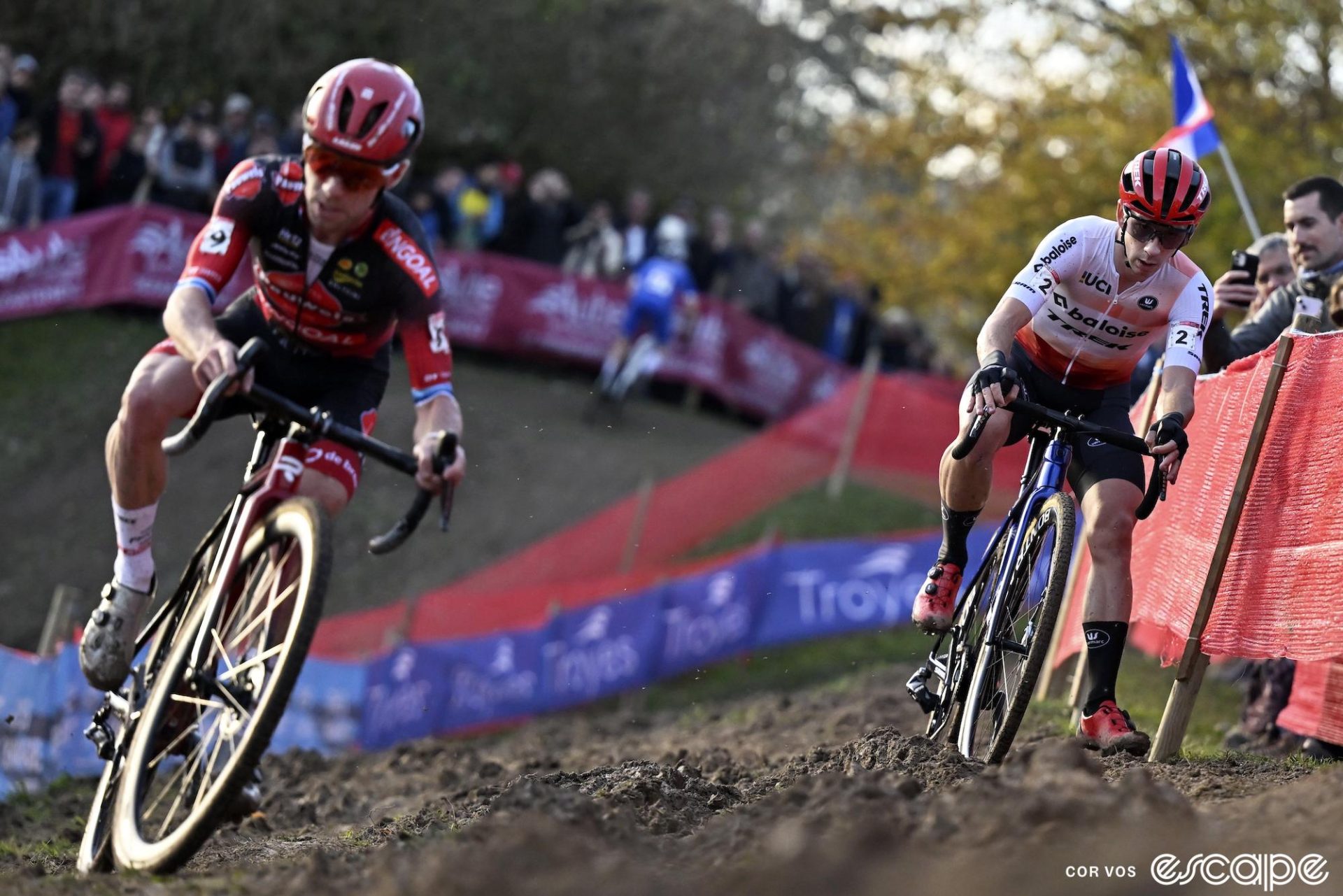 Eli Iserbyt and Lars van der Haar fight the off-camber section to stay up right. Eli, in front, is slightly out of focus as he leans his bike into the hill, while Van der Haar, behind, is sharply in focus as he puts a foot down for balance.