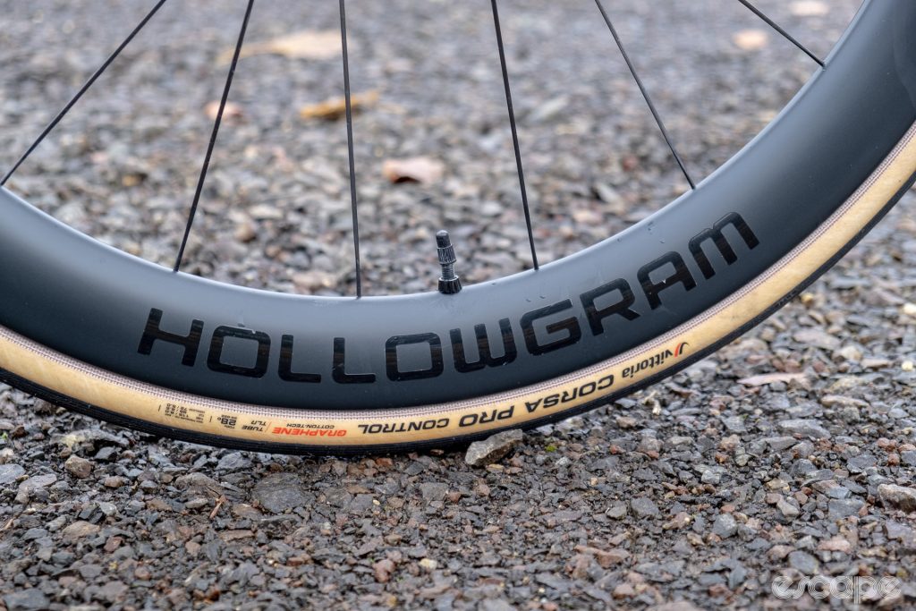 The photo shows the HollowGram logo and hidden spoke nipples on the new HollowGram R-SL 50 front wheel on a new Cannondale SuperSix Evo Hi-Mod 2.