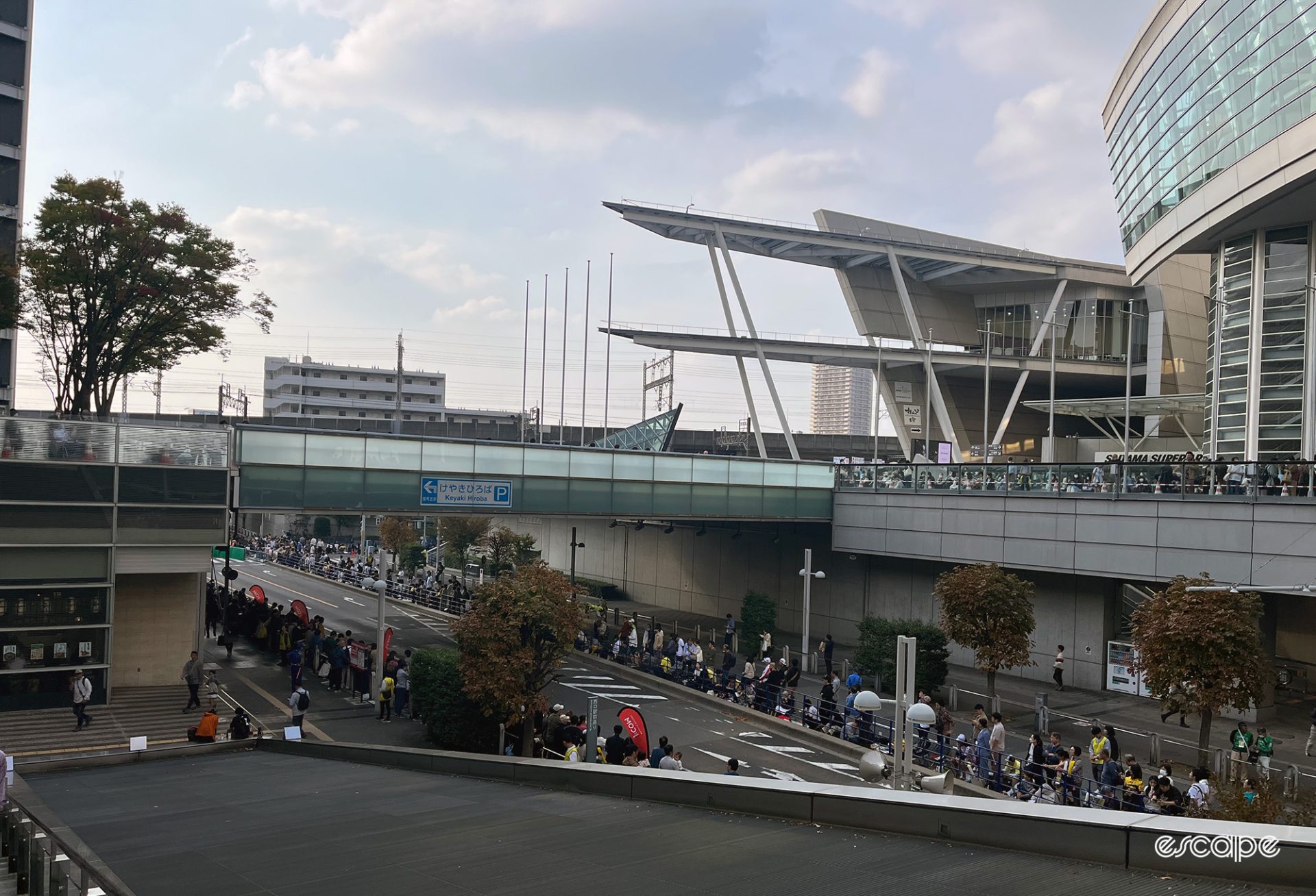 Crowds line the road waiting for the Saitama Criterium below the Saitama Super Arena.