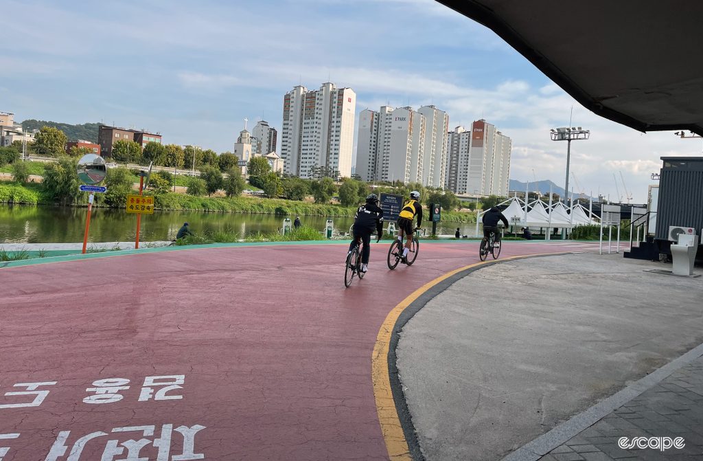 Cyclists emerge from an underpass on a Seoul bike path.
