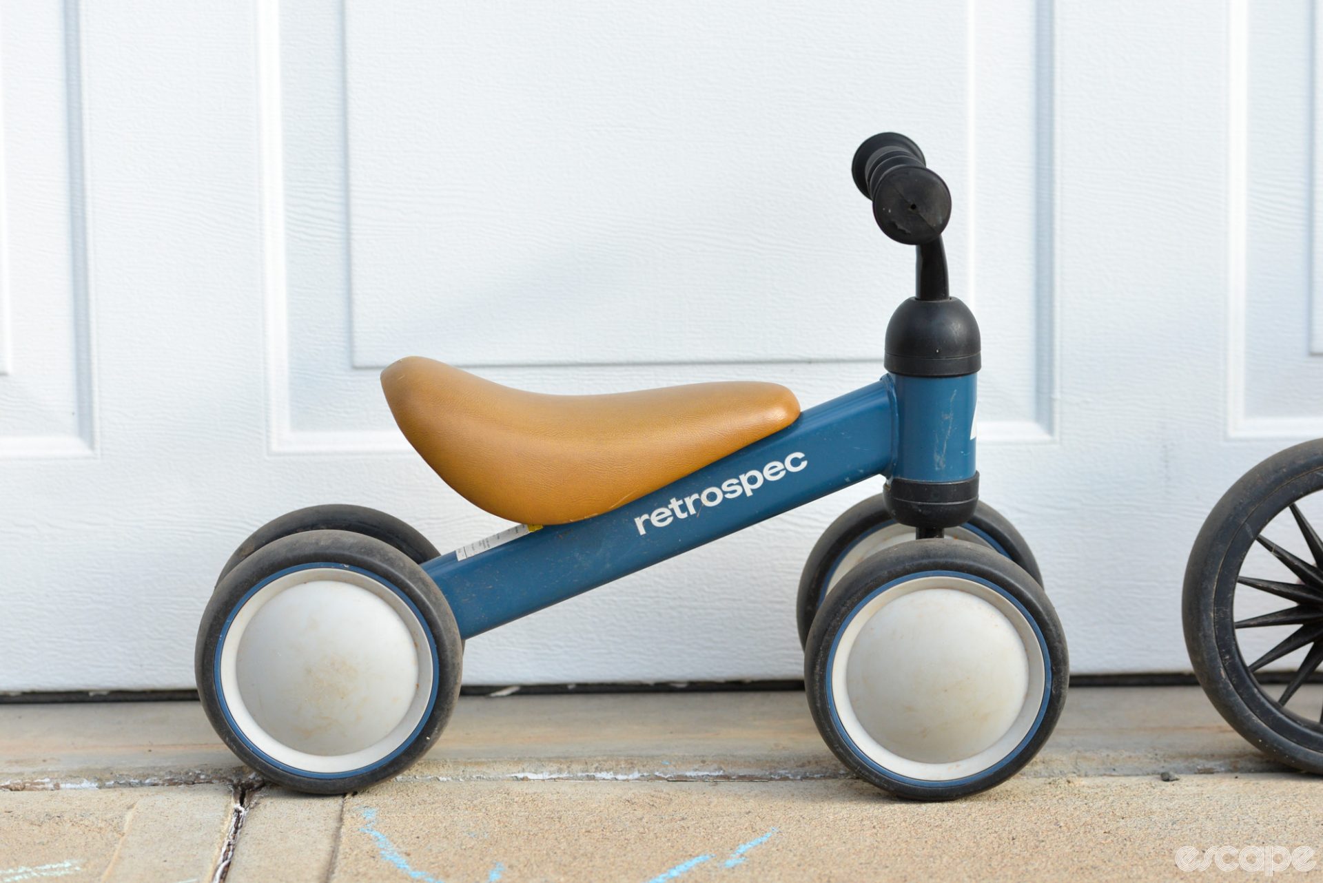 Retrospec's Cricket kids bike from the side. It has four tiny wheels, a large seat, and a 90-degree head angle.