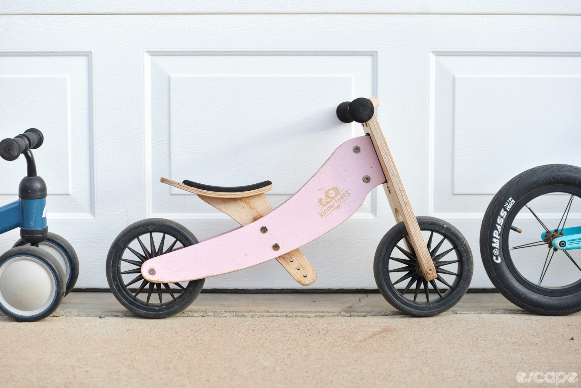 The Kinderfeets 2-in-1 from the side, which shows its laminated wood construction and simple, three-piece frame with a seat that goes very low.