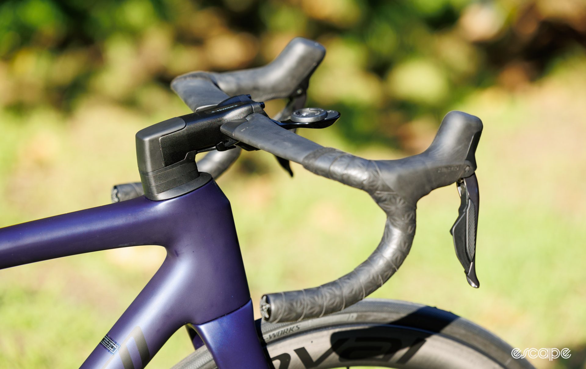 A photo showing the handlebars and head tube from side-on. 