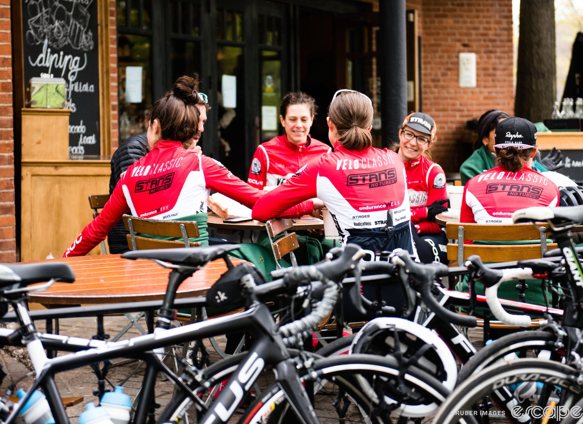 A group of female cyclists gather for a coffee around a group ride. 