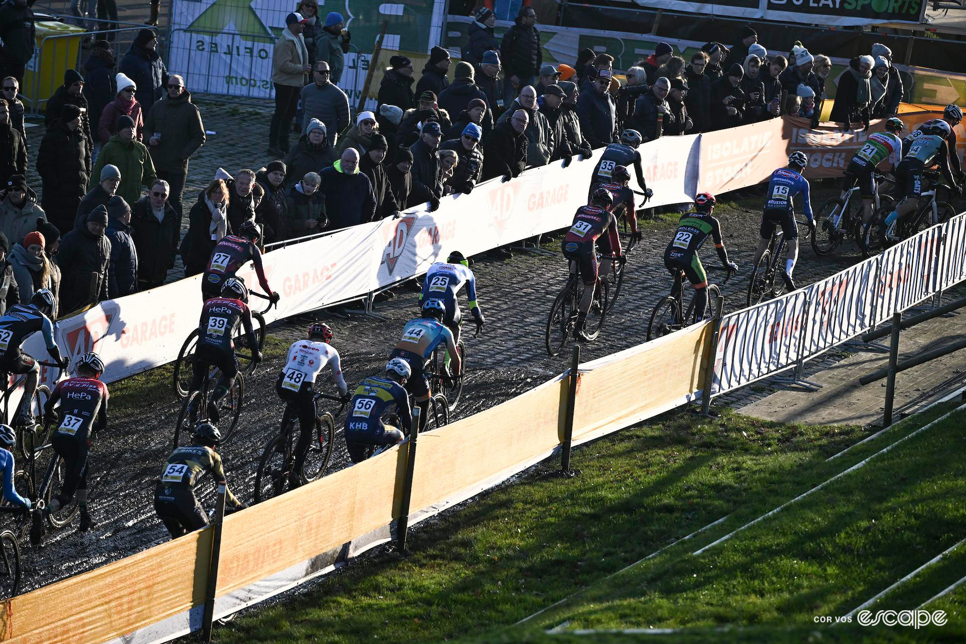 The men's field passes alongside the crowd during Cyclocross Superprestige Boom.
