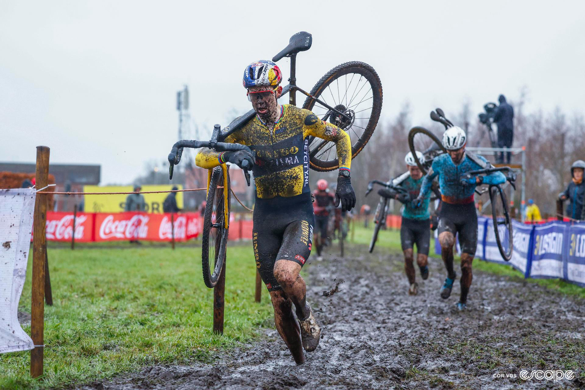 Wout van Aert during a very wet and muddy Exact Cross Essen, Jens Adams chasing in the background.