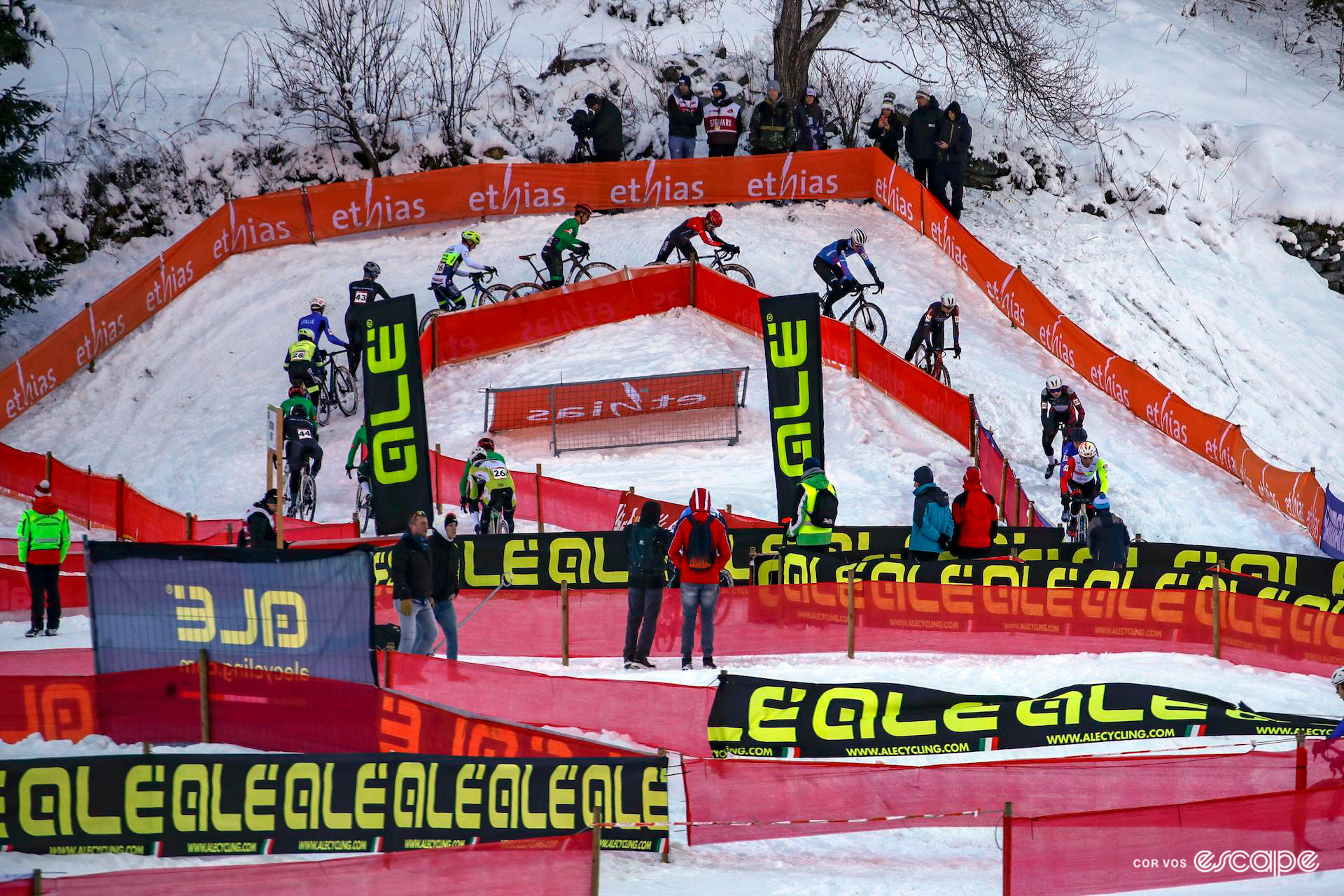 The elite men's field navigates the snow-covered course during UCI Cyclocross World Cup Val di Sole.
