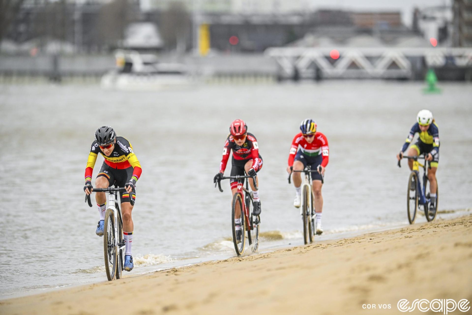 Sanne Cant leads a line of riders on the beach section.