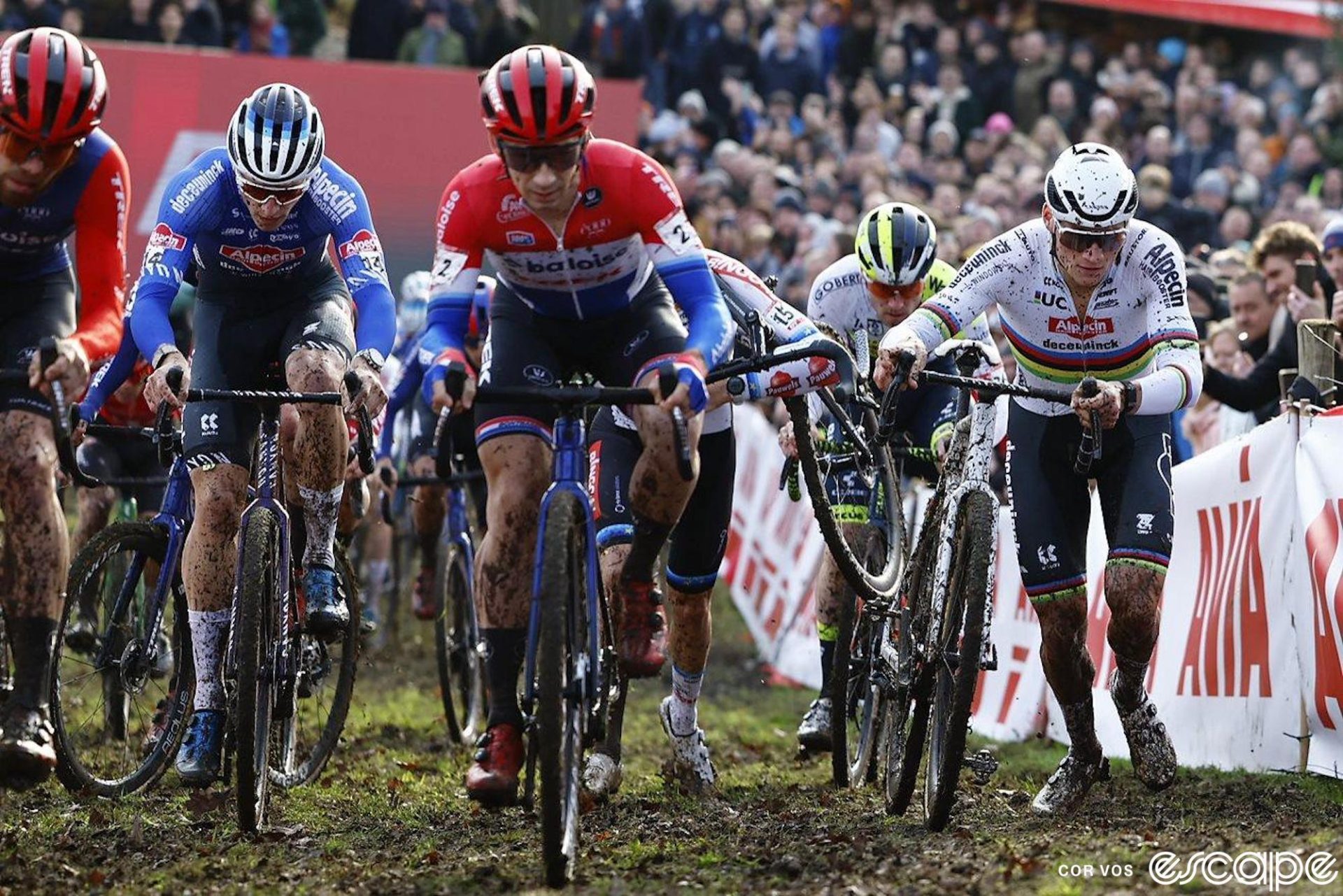 Mathieu van der Poel pushes his bike up a muddy section in traffic at Gavere.