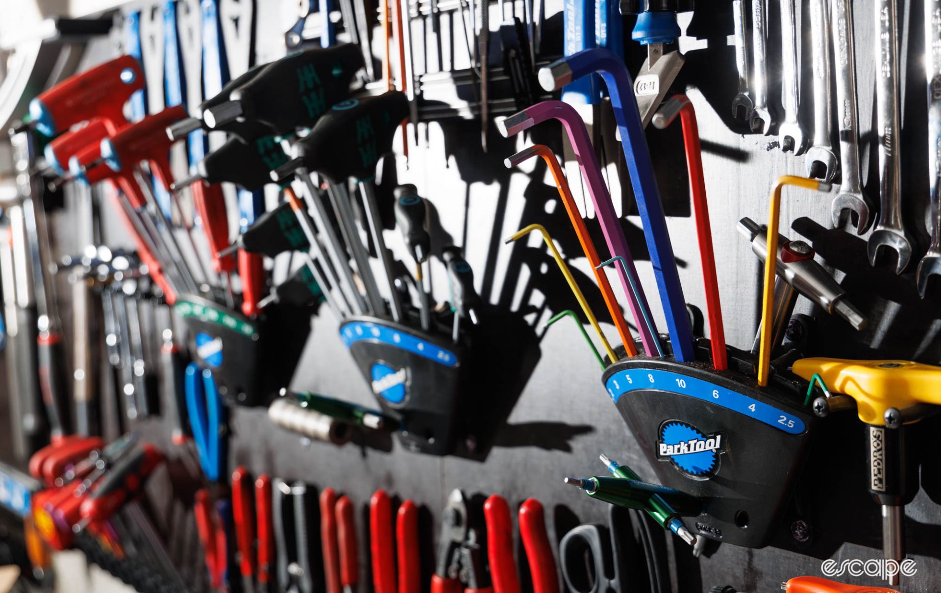 A wall of tools with three Park Tool hex key and Torx key holders shown. 
