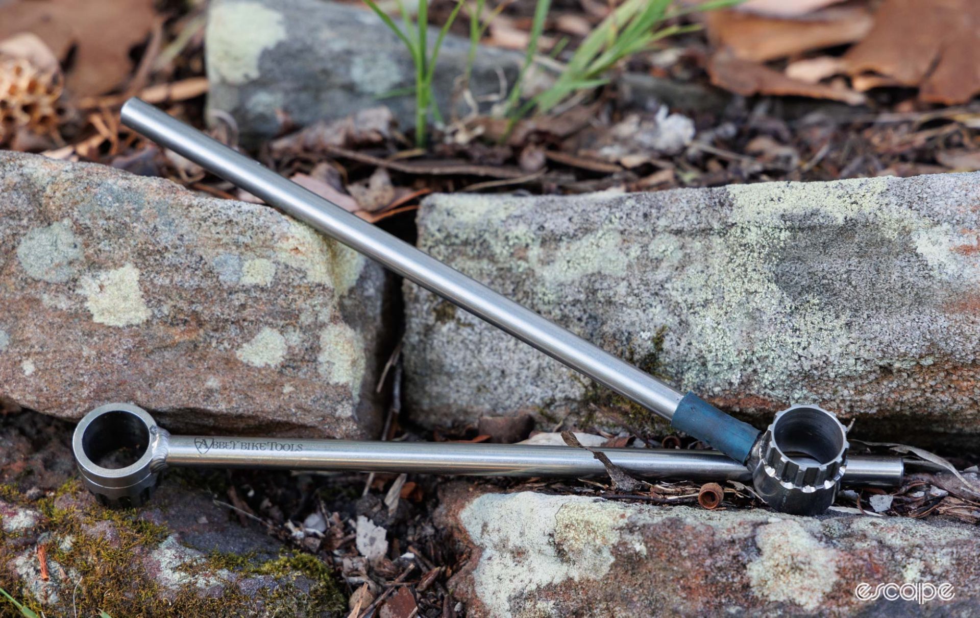 Campagnolo and Shimano single-sided versions of the Abbey Bike Tools Crombie sitting on a rock. 