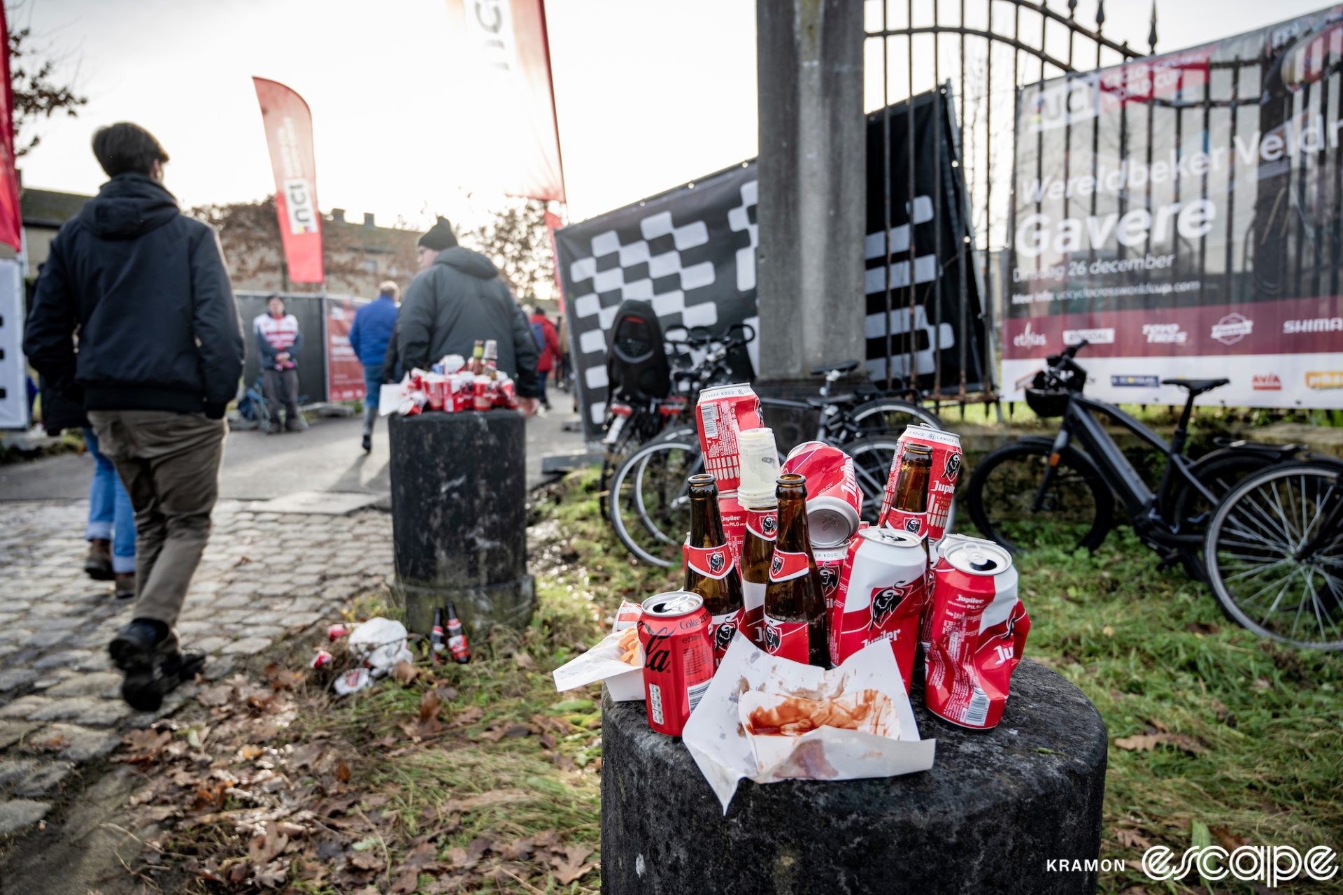 Stacks of beer cans sit atop stone bollards at the entrance to the Gavere World Cup venue.