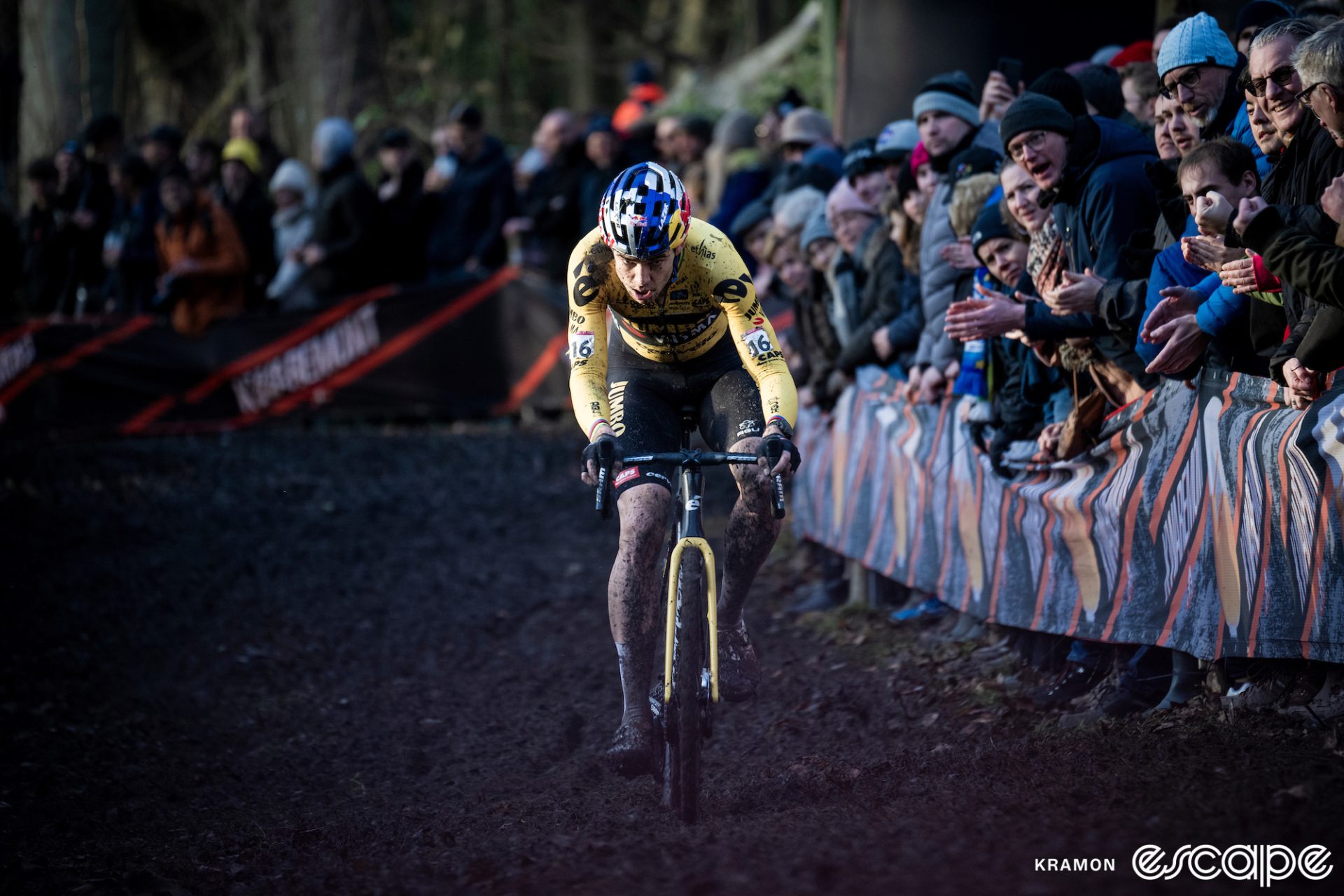 Wout van Aert is alone chasing in the mud.