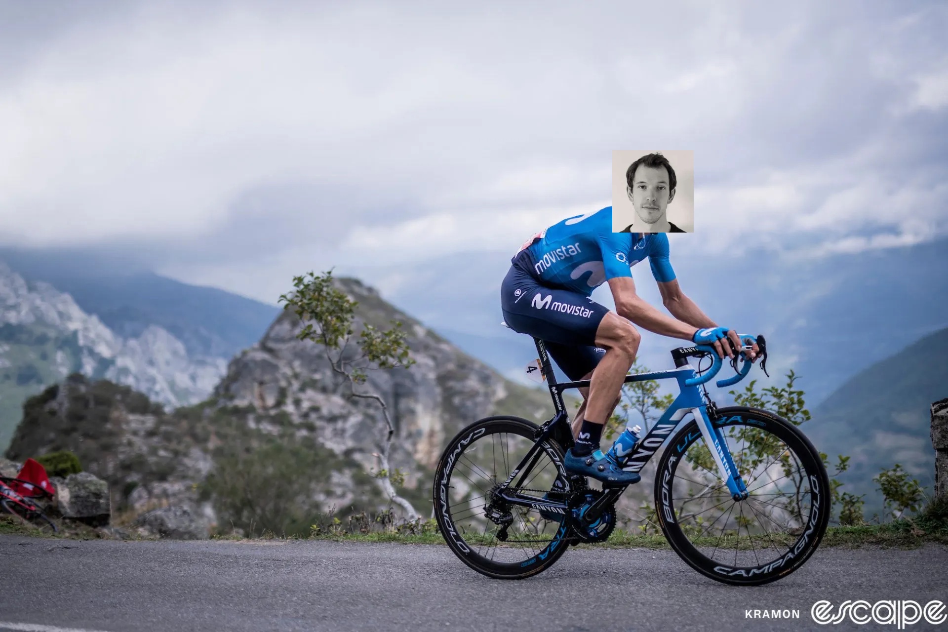 Imanol Erviti rides up a climb in the 2019 Vuelta a España. Andy McGrath's mug is pasted over Erviti's head in a janky Photoshop job.