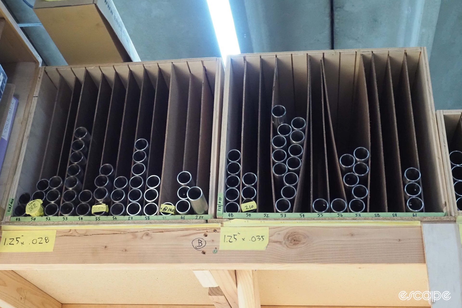 A stack of main tubes sits divided by cardboard spacers.