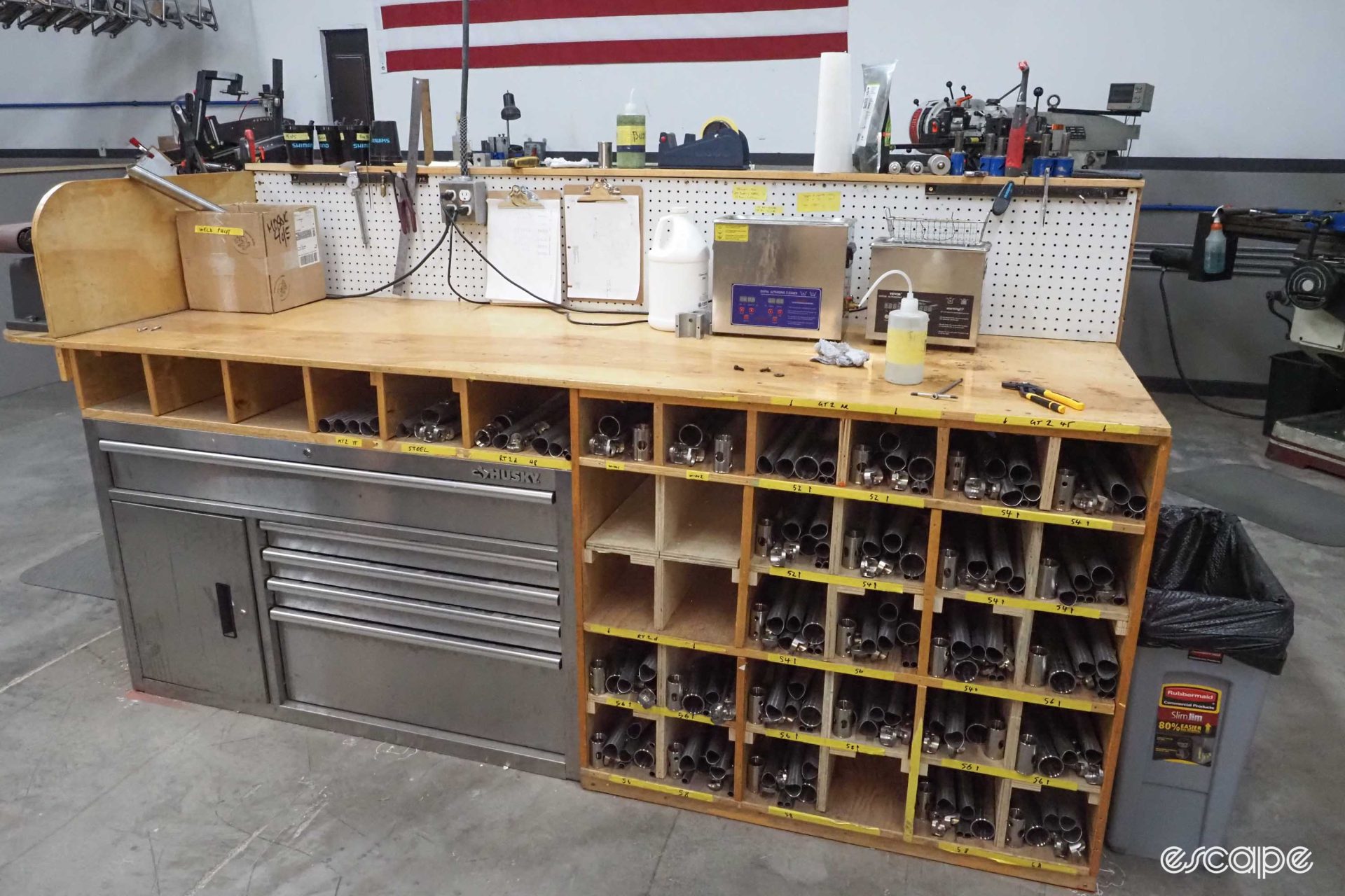 Another neat workbench in the Mosaic factory, with a cubby underneath divided into storage for various builds - each cubby contains an order.