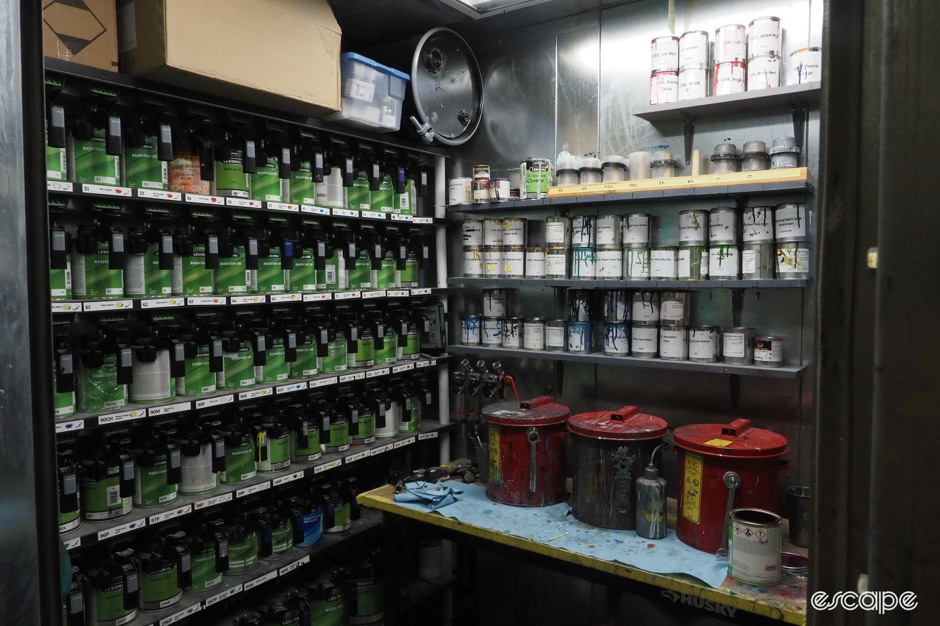 Cans and cans of paint, stacked on shelves.