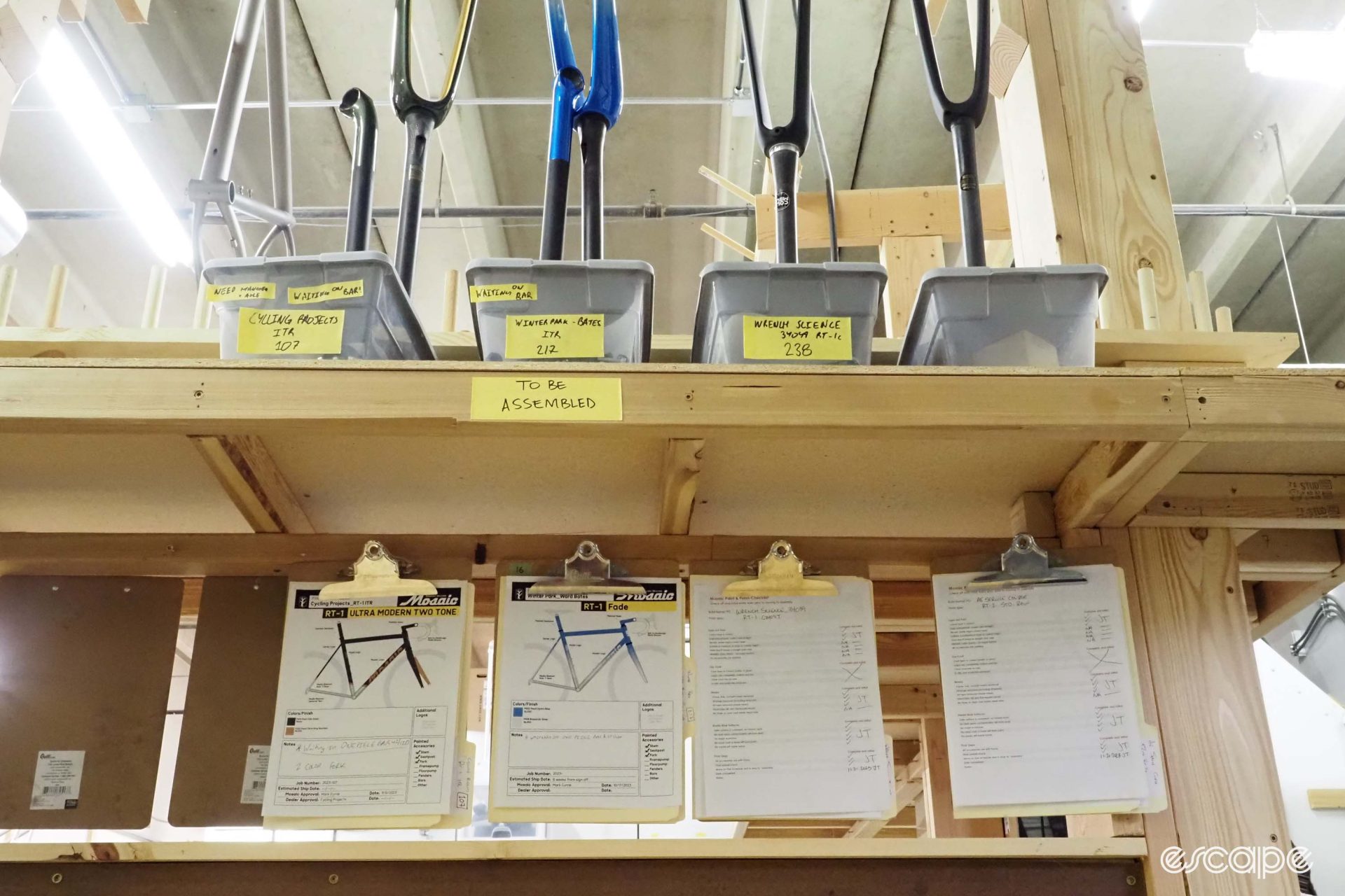 Clipboards with order sheets hang in a neat row.