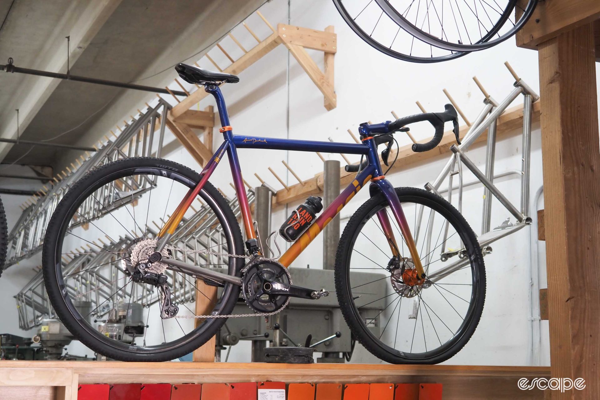 A gravel bike finished in a blue to red to orange fade.