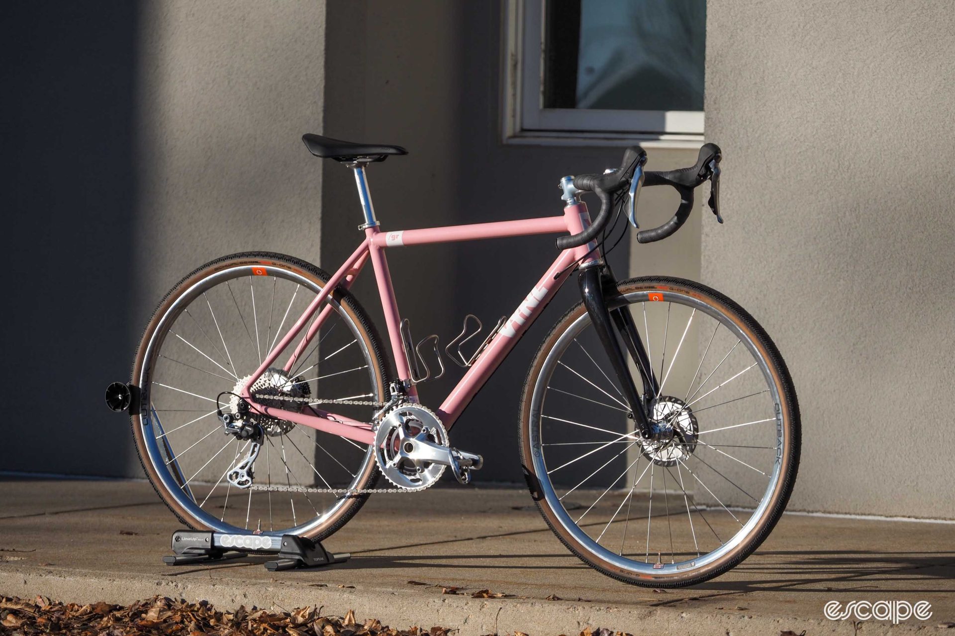 Pink Vynl aluminum gravel bike front three-quarter view