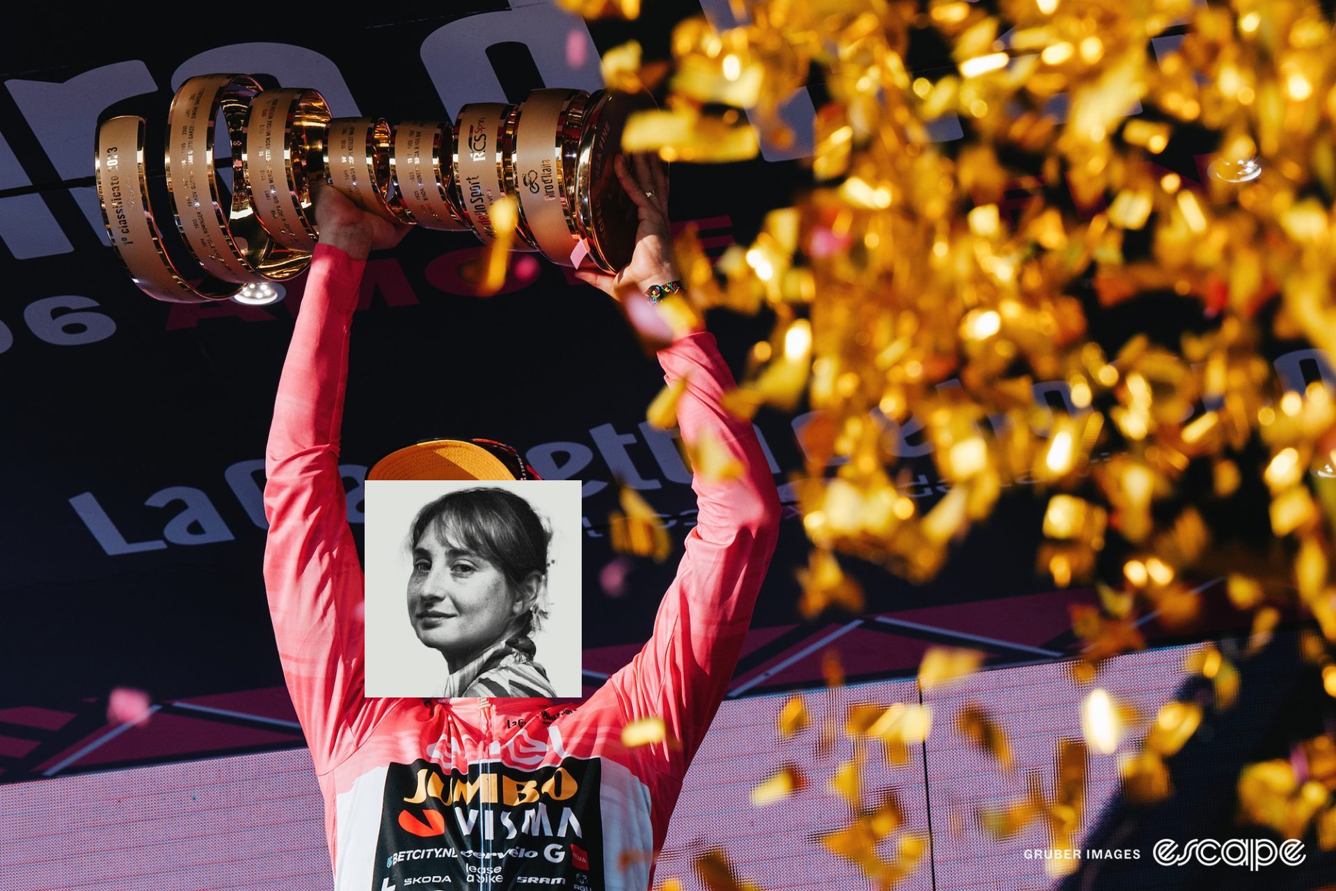 Primož Roglič holds the Giro d'Italia trophy over his head on the podium. Kate Wagner's profile photo is jankily edited in place of his face.