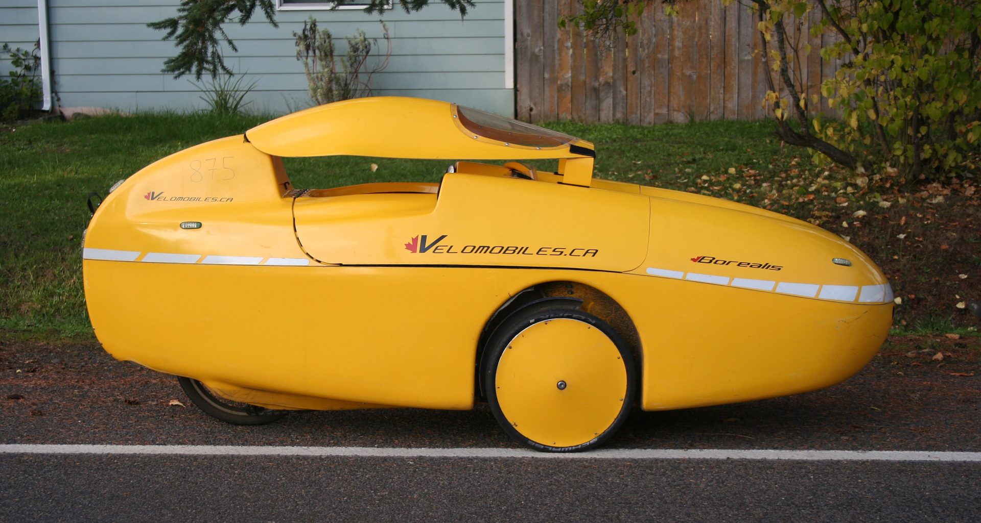 A side on view of the Borealis. It's a solid yellow vehicle. 