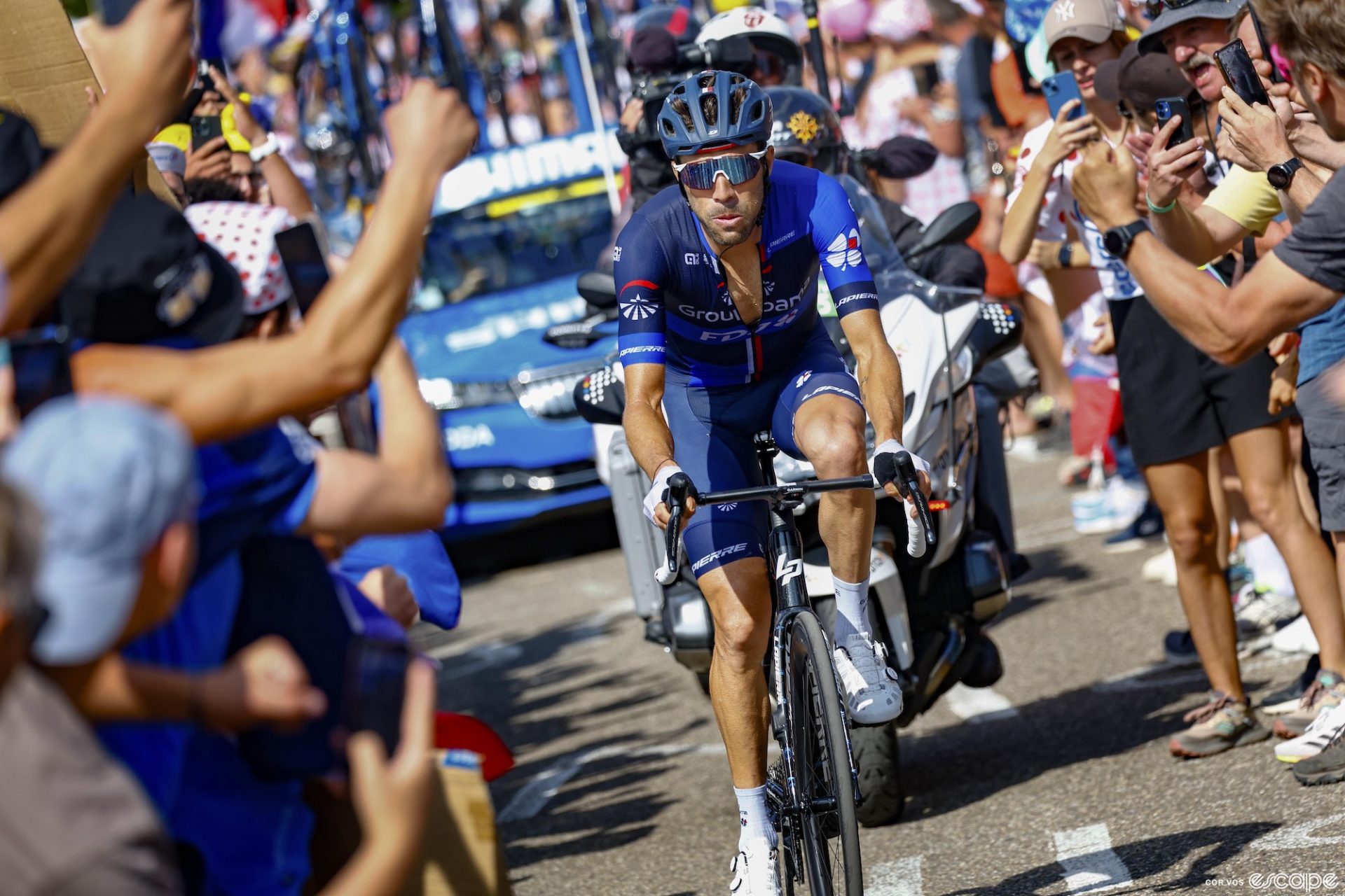 Thibaut Pinot rides through a crowd of fans at the Tour de France.