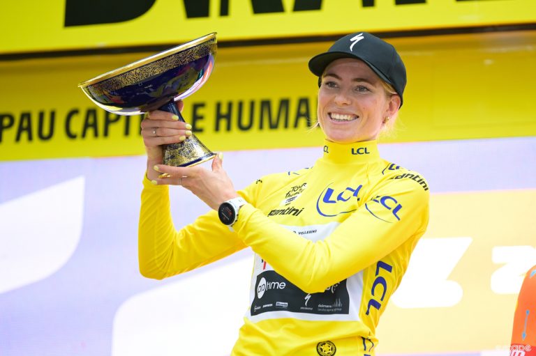 Demi Vollering holds up her new Tour de France Femmes trophy after winning the 2023 Tour.