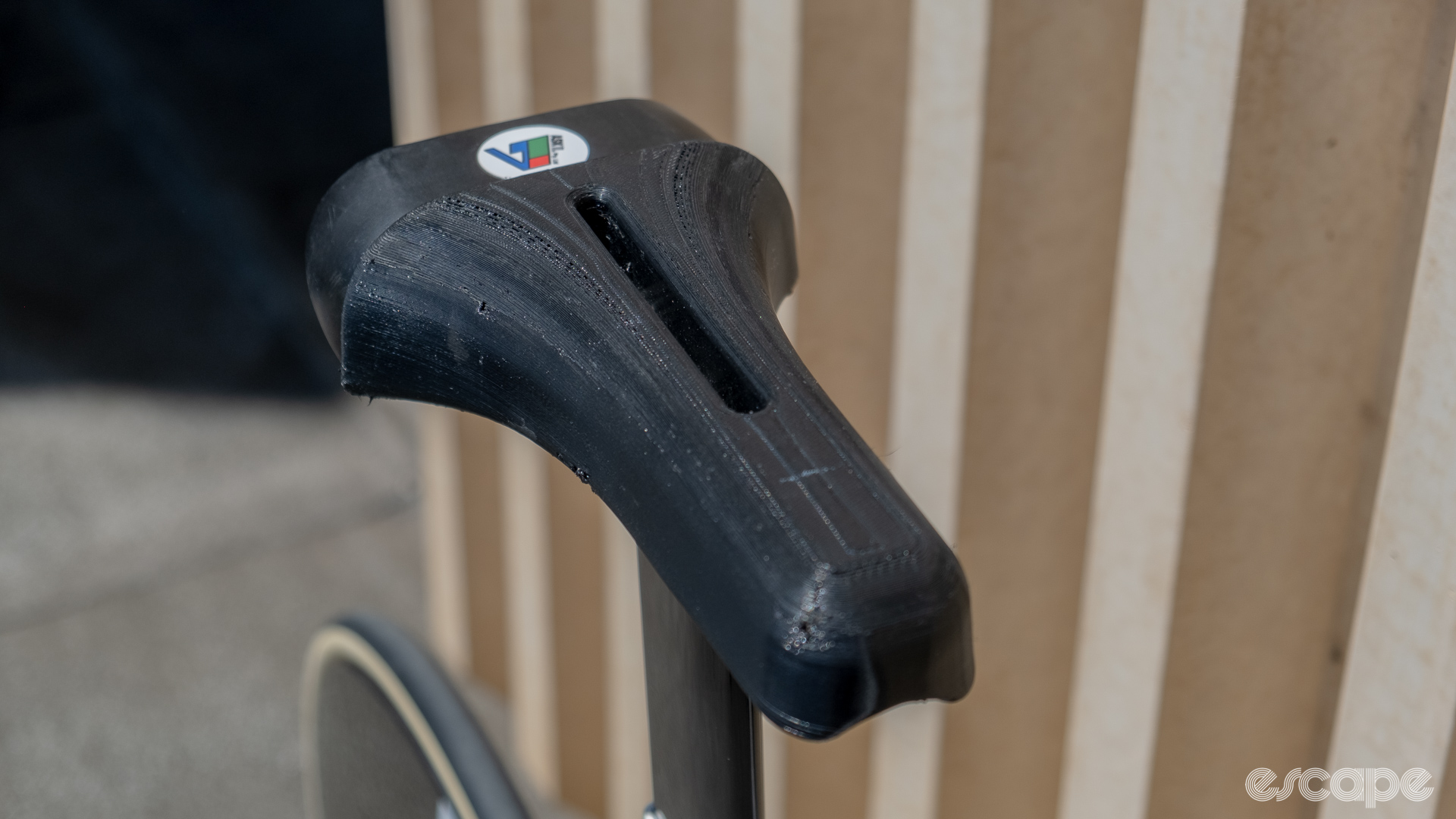 The photo shows the 3D printed saddle on AusCycling's Factor Hanzo Track pursuit bike.