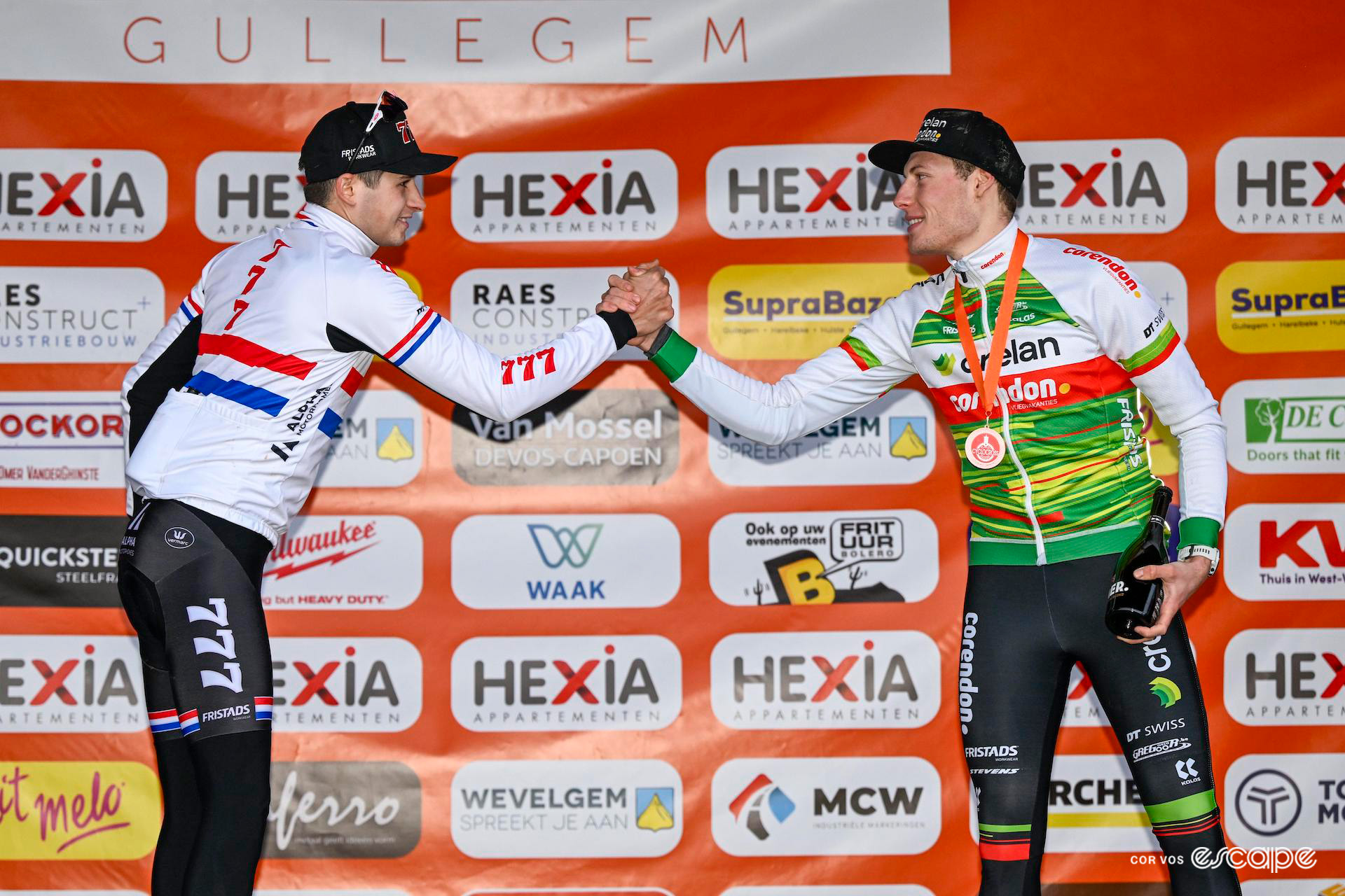 Cameron Mason and Joran Wyseure clasp hands in mutual congratulation on the podium after Hexia Cyclocross Gullegem.