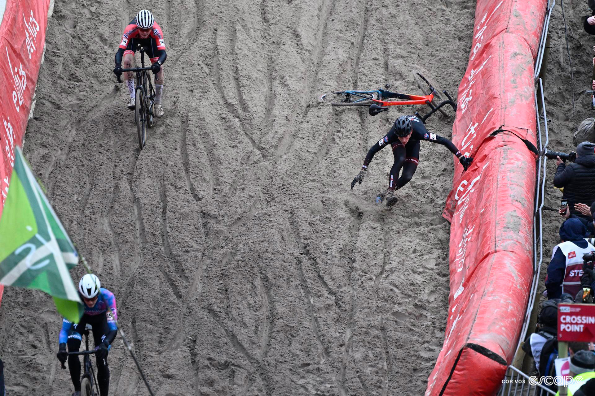 A rider takes a tumble on the fast sandy descent into the pit during UCI World Cup Zonhoven.