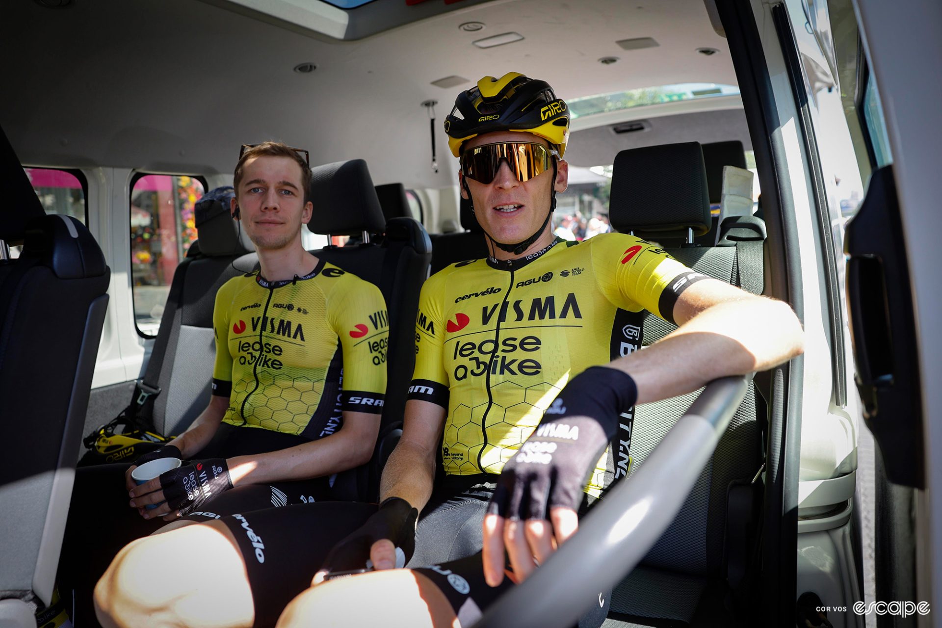 Bart Lemmen sitting next to Robert Gesink in a team bus before the start of a Tour Down Under stage.