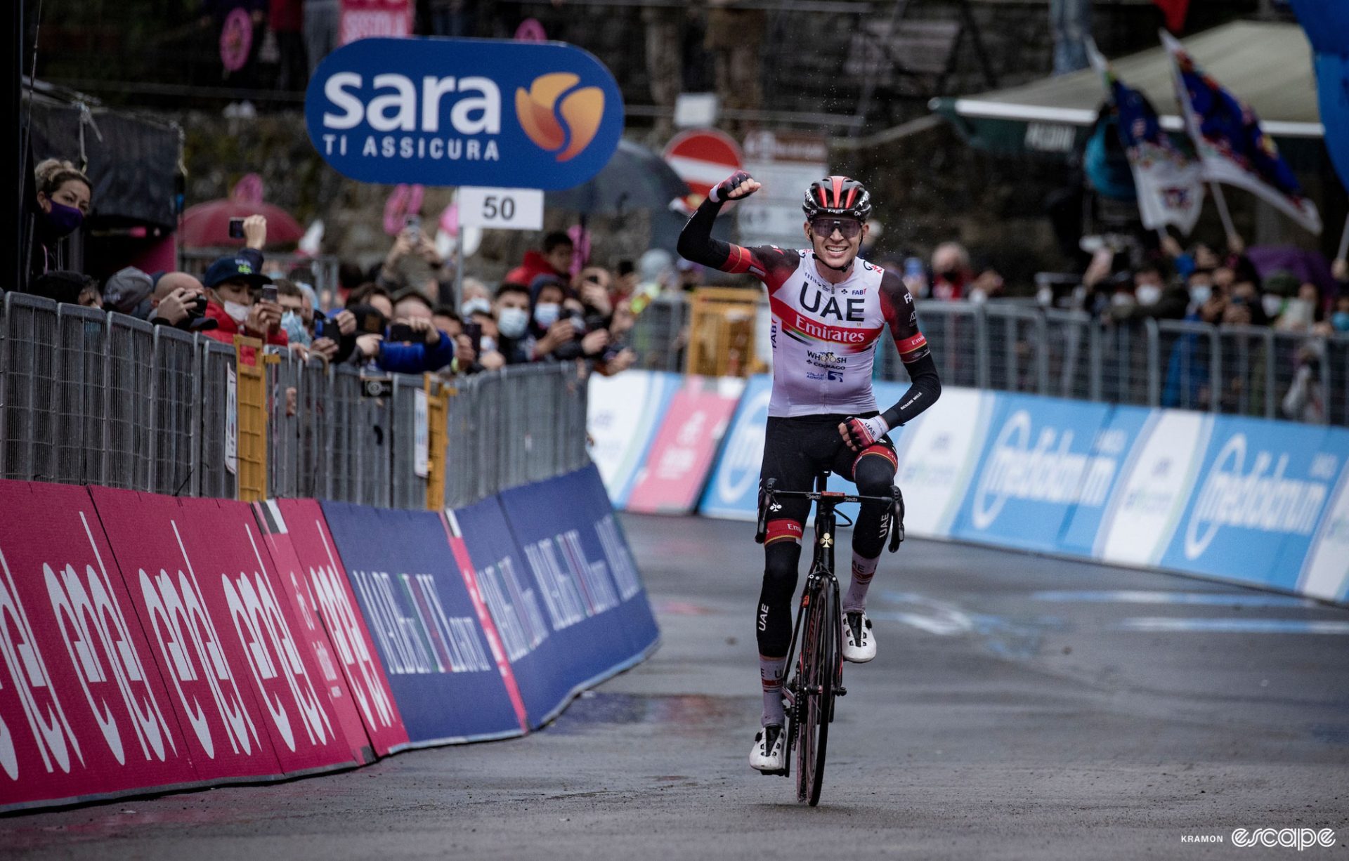 Joe Dombrowski sits up and punches the air as he crosses the finish line to win a stage of the 2021 Giro d'Italia.