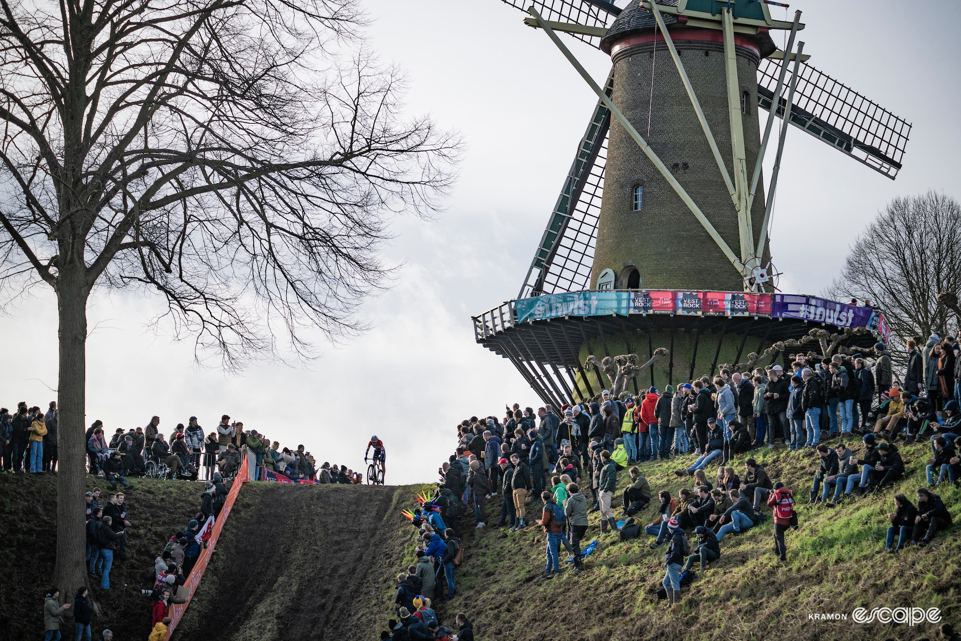 Wide view of race leader Puck Pieterse about to take on the steep descent from the windmill during CX World Cup Hulst.