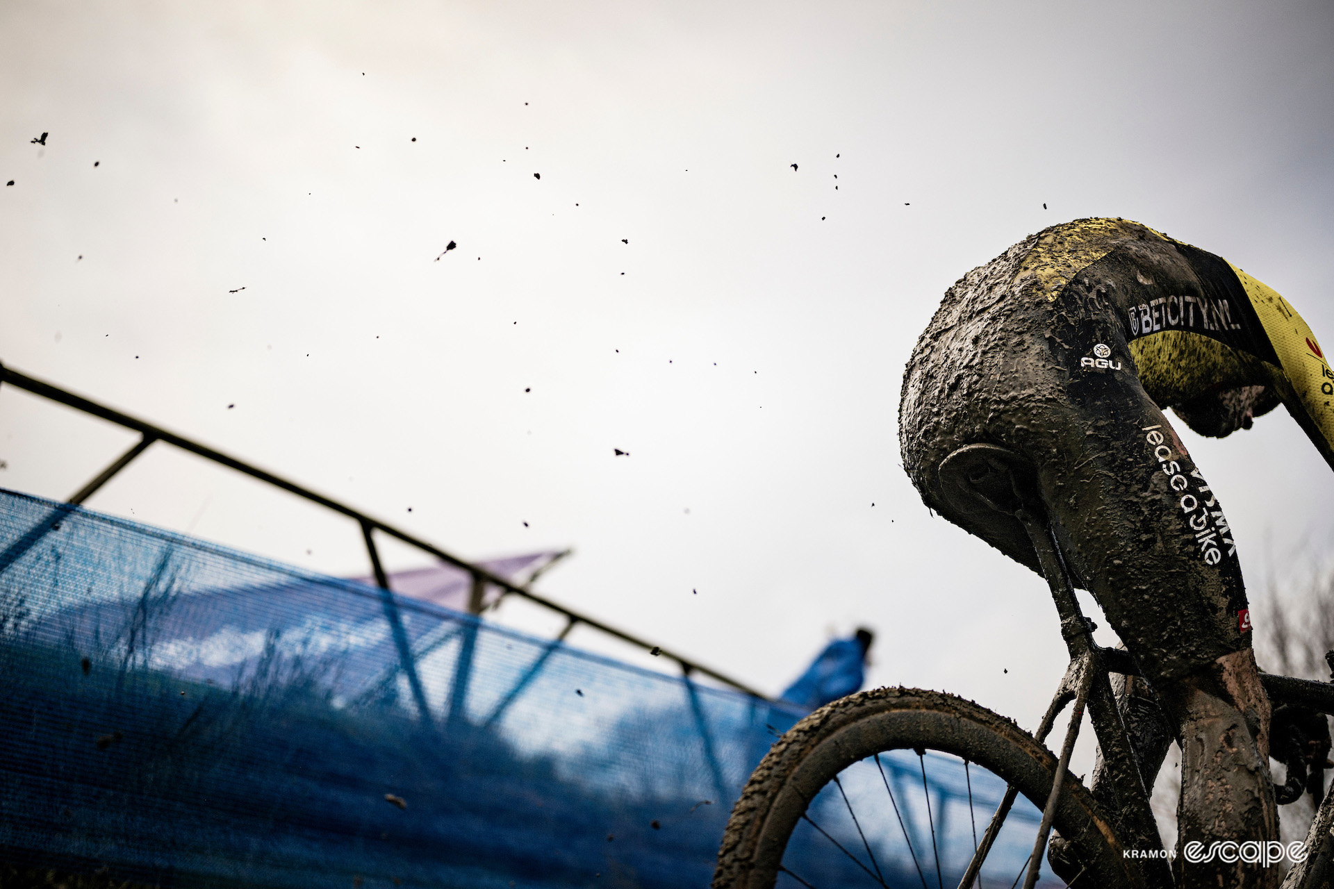 A mud-covered Wout van Aert kicks up dirt during GP Sven Nys.