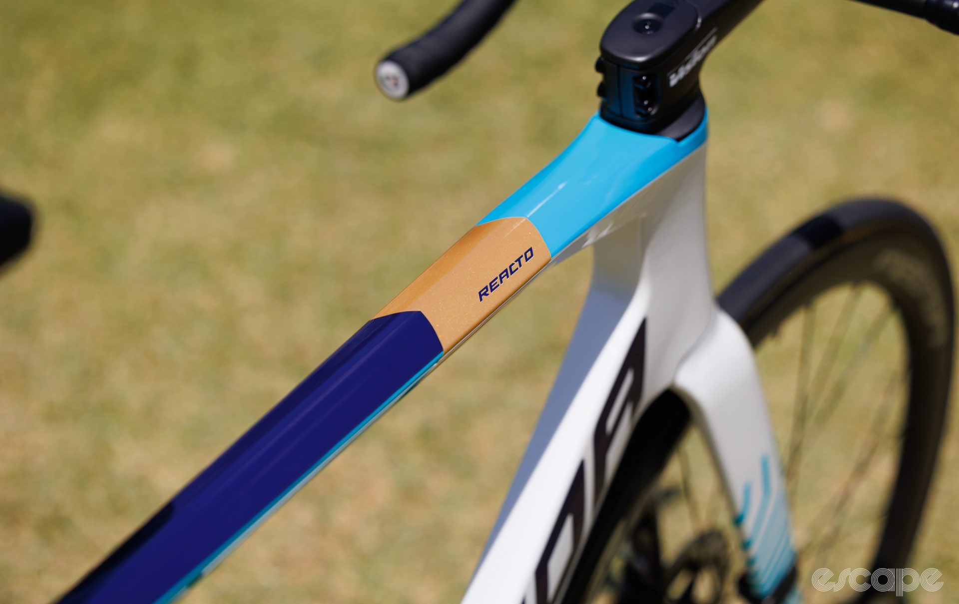 Distinctive paint with blocked light blue, tan, and dark blue sections on the top tube.