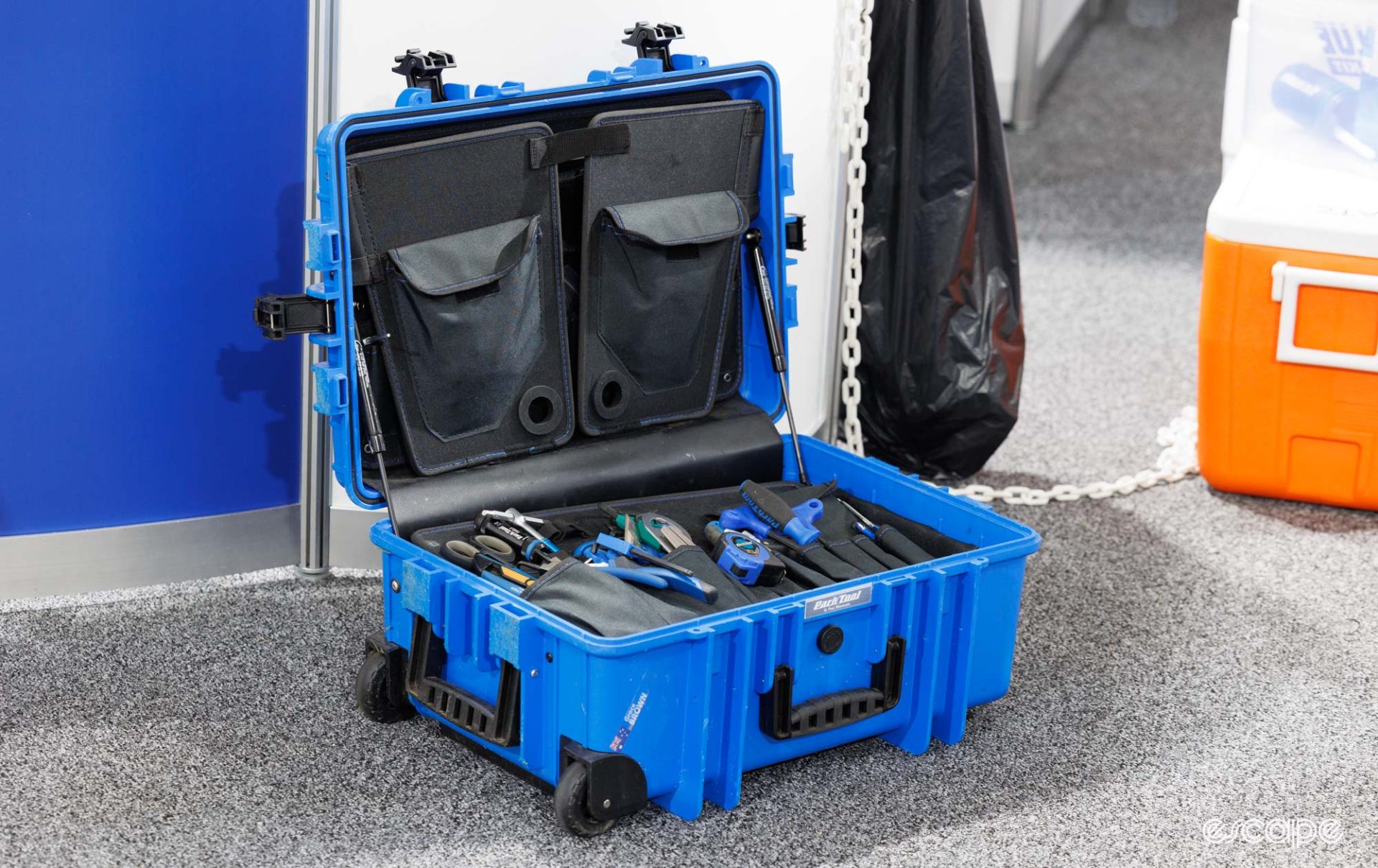 A large Park Tool case sits on the floor, filled with blue tools. 