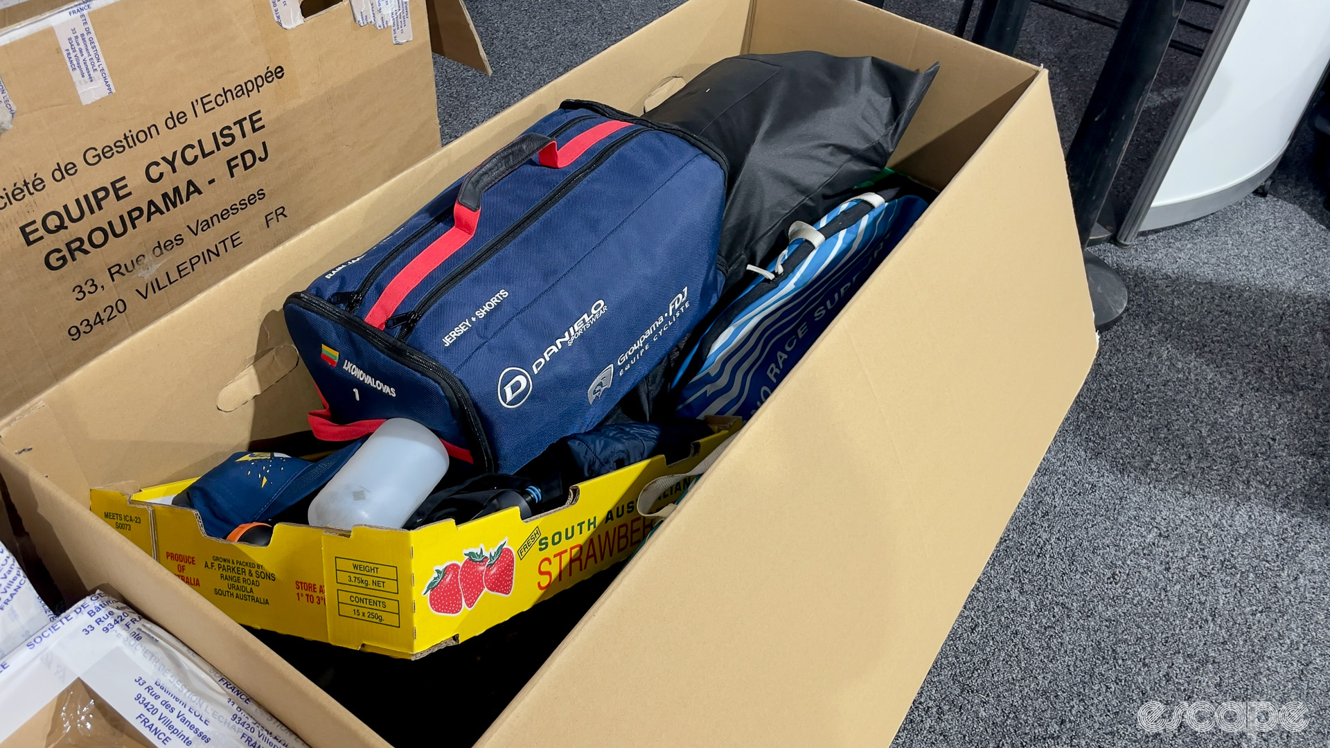 The photo shows a box almost full with various items.