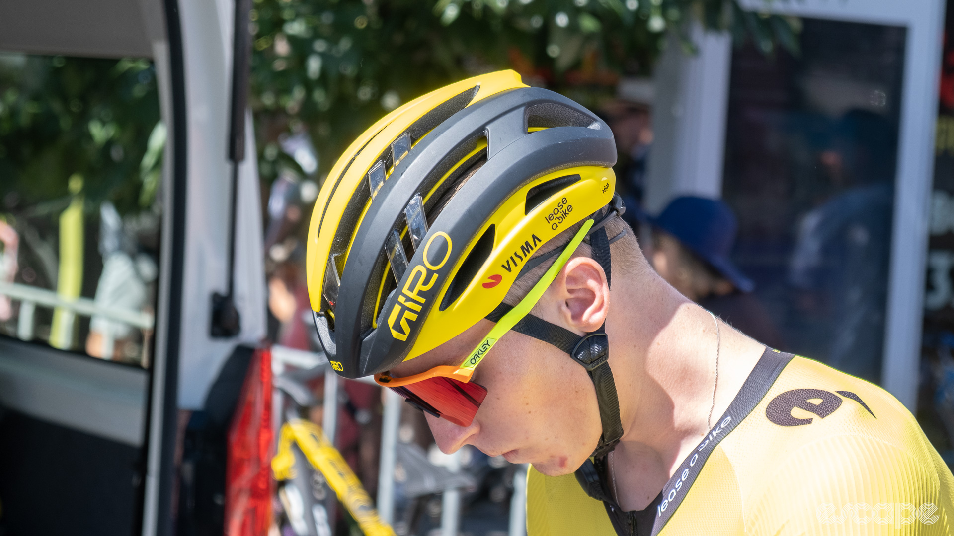 The photo shows a Visma-Lease a Bike rider wearing a vented Giro helmet. 