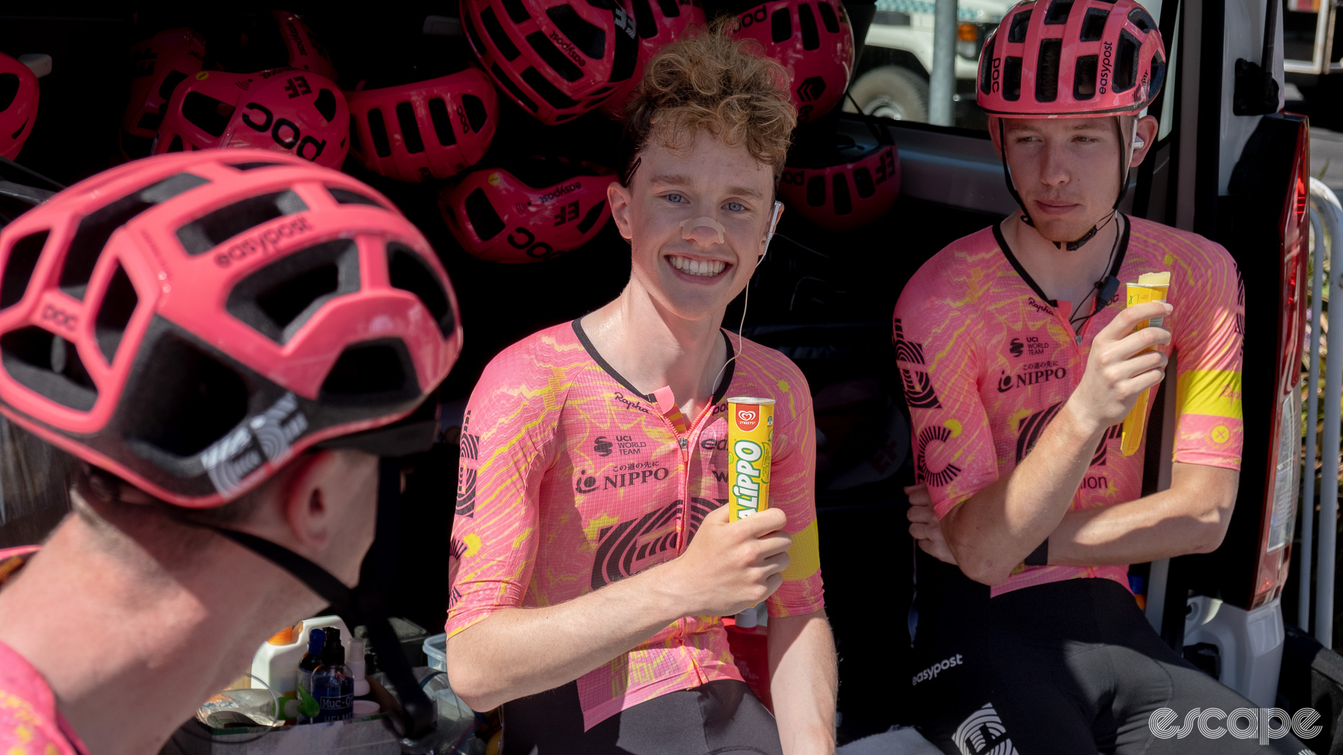 The photo shows Archie Ryan and two other Ef Education - Easypost riders eating Calippo ice lollies before a stage start.