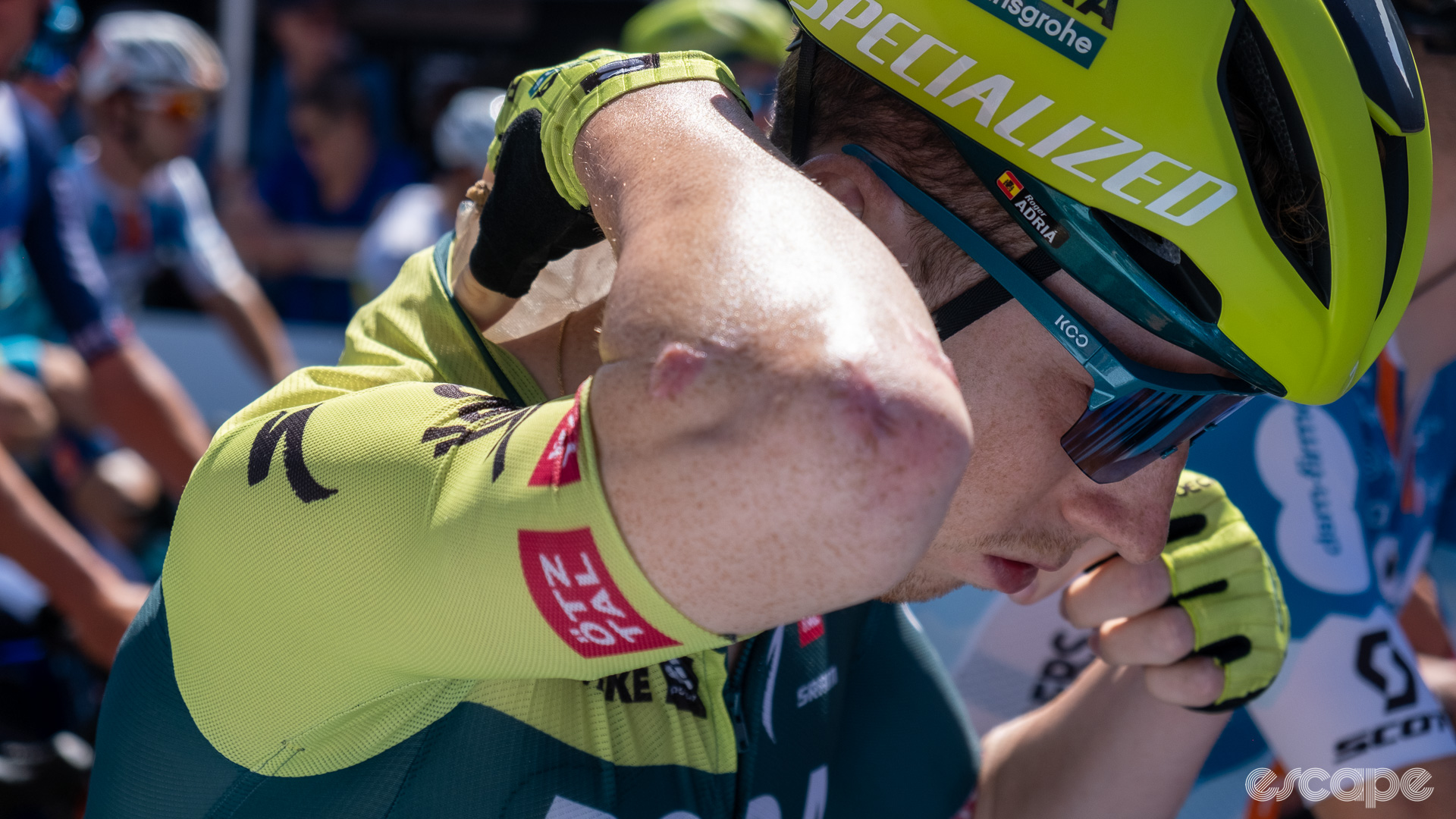 The photo shows a Bora-Hansgrohe rider putting an ice sock inside his jersey onto his neck.
