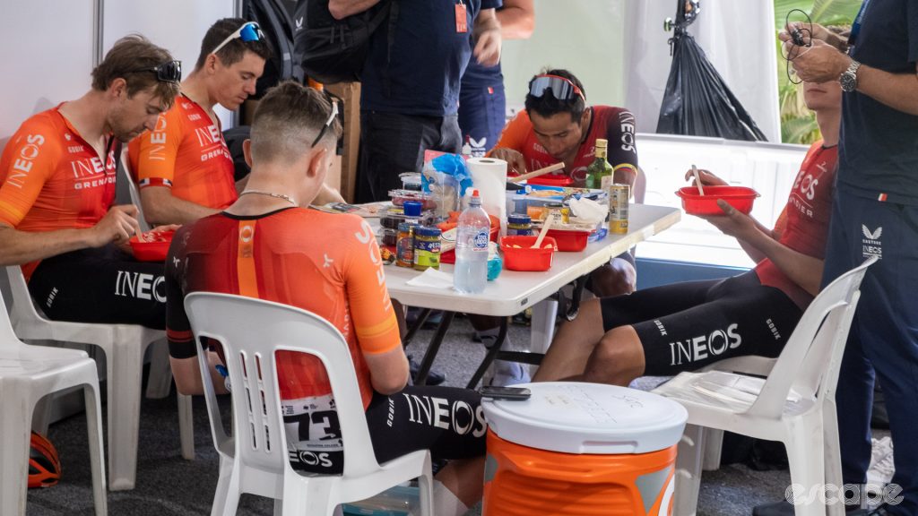 The photo shows Ineos Grenadiers riders eating lunch.