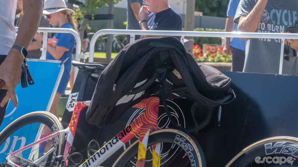 The photo shows a wheel bag laid over the handlebars of a Cannondale bike to protect them from the sun and reduce heat buildup on the bars.