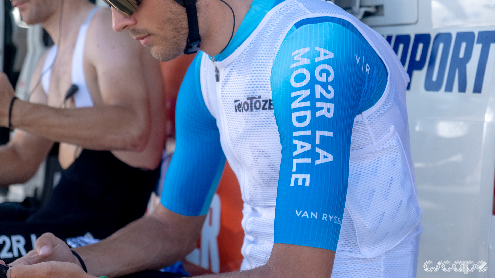 The photo shows a Decathlon-AG2R La Mondiale rider wearing a white mesh Velotoze ice vest.