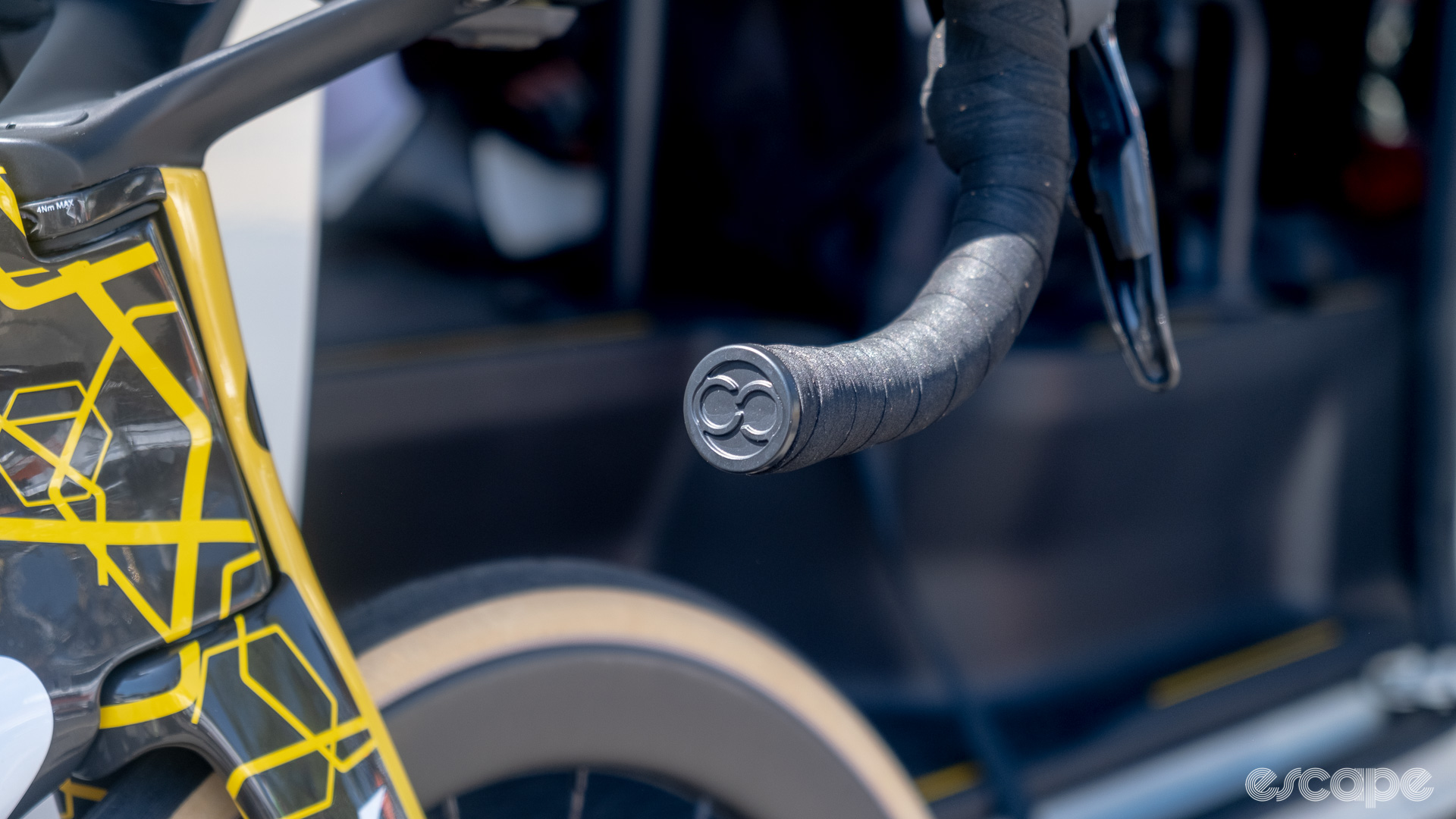 The photo shows the bar end plug on a Visma-Lease a bike Cervelo. 