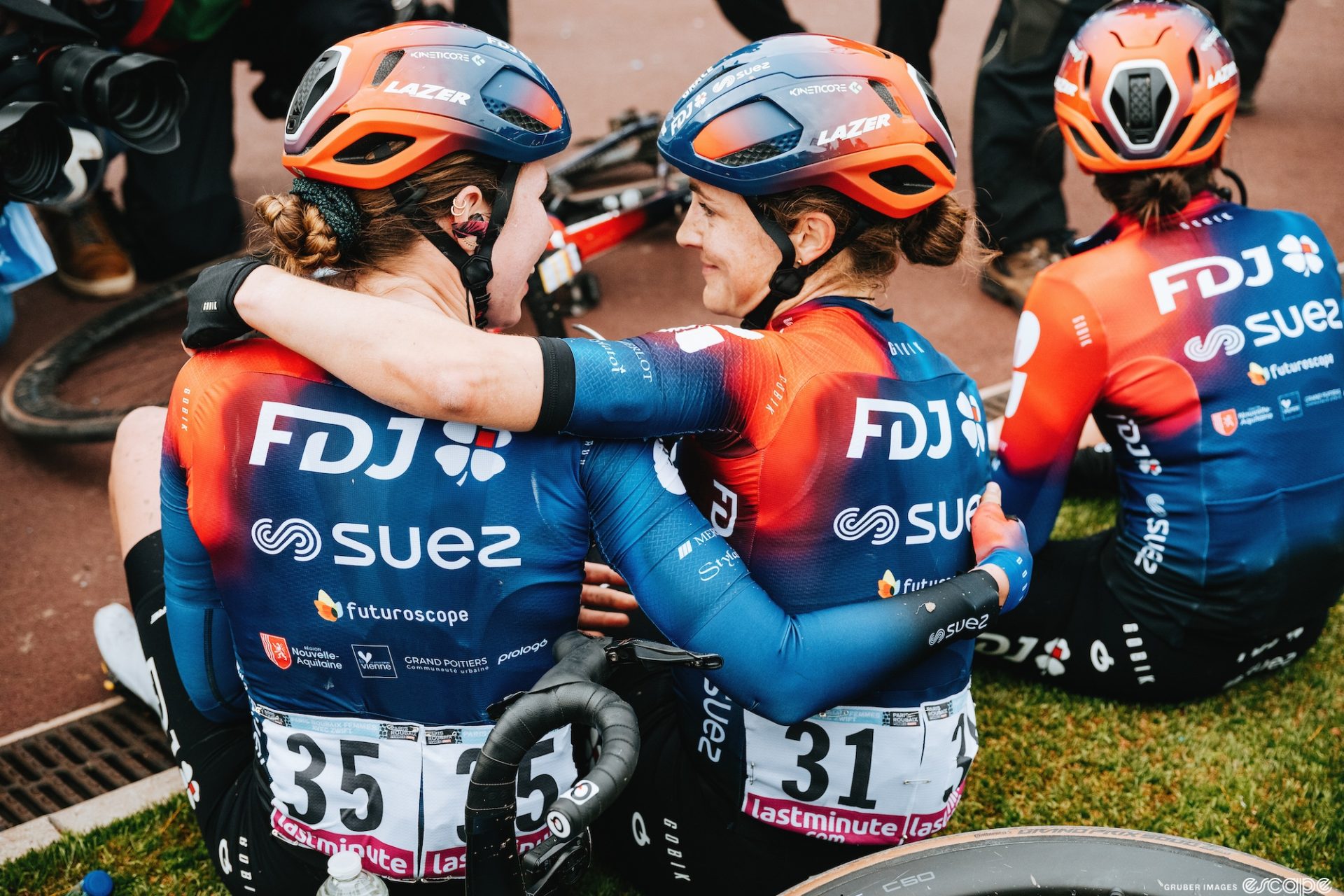 Grace Brown and Marie Le Net smile at each other near the side of the Velodrome after the finish of Paris-Rouabix femmes. 
