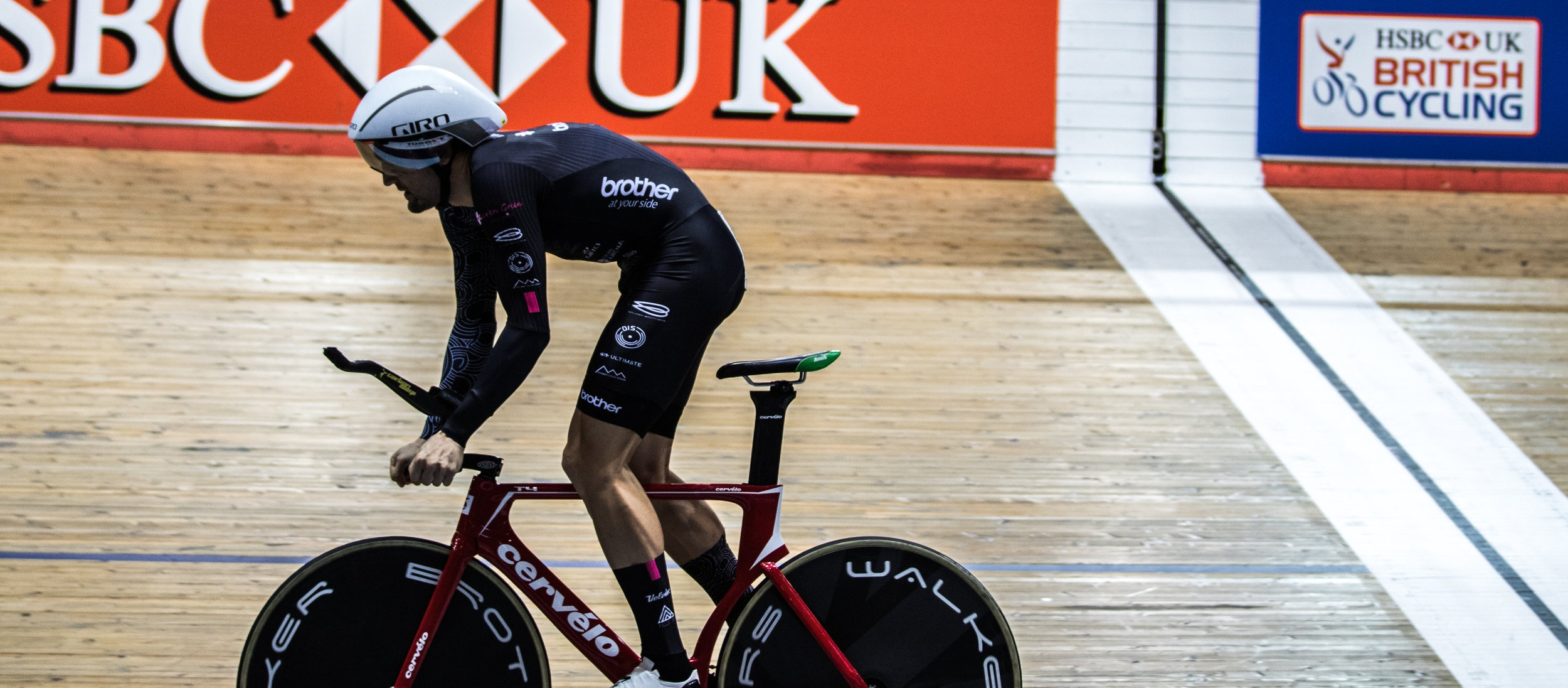 The photo shows Jacob Tipper starting an individual pursuit on Manchester velodrome.