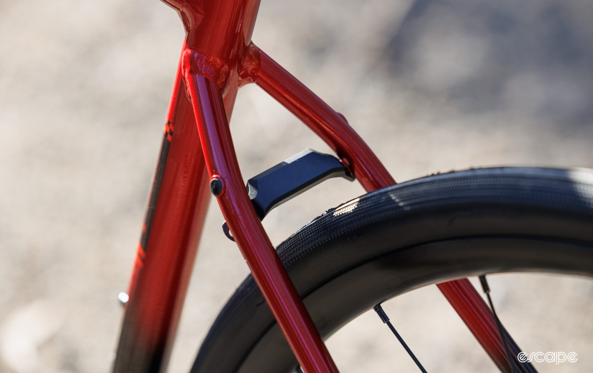 A close-up photo showing the plastic seatstay bridge used for mounting a fender. 